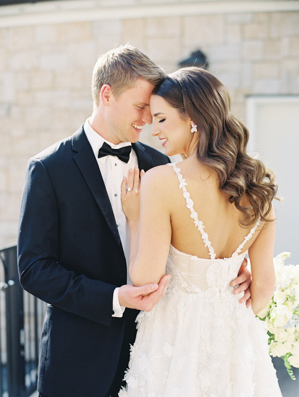 bride nuzzled into groom photo
