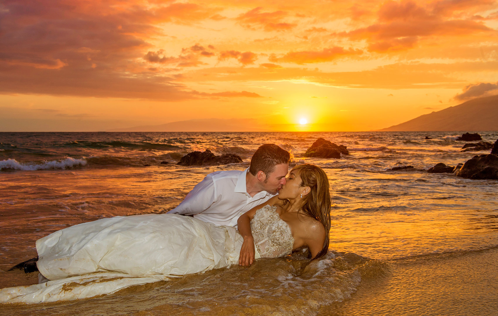 Rolling on the sand in the water, they totally trash the dress for the camera.