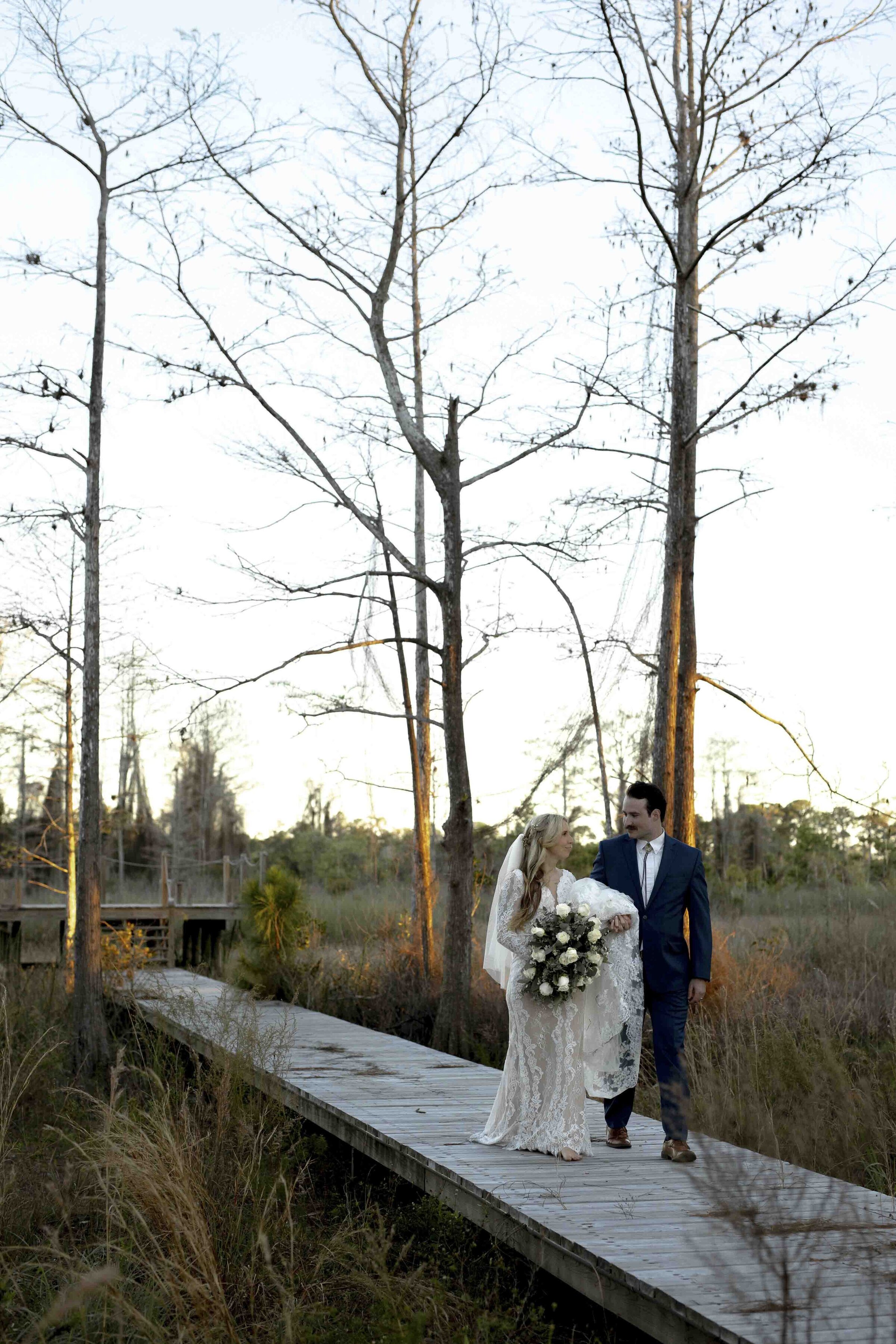 Bride and groom walking on a bridge