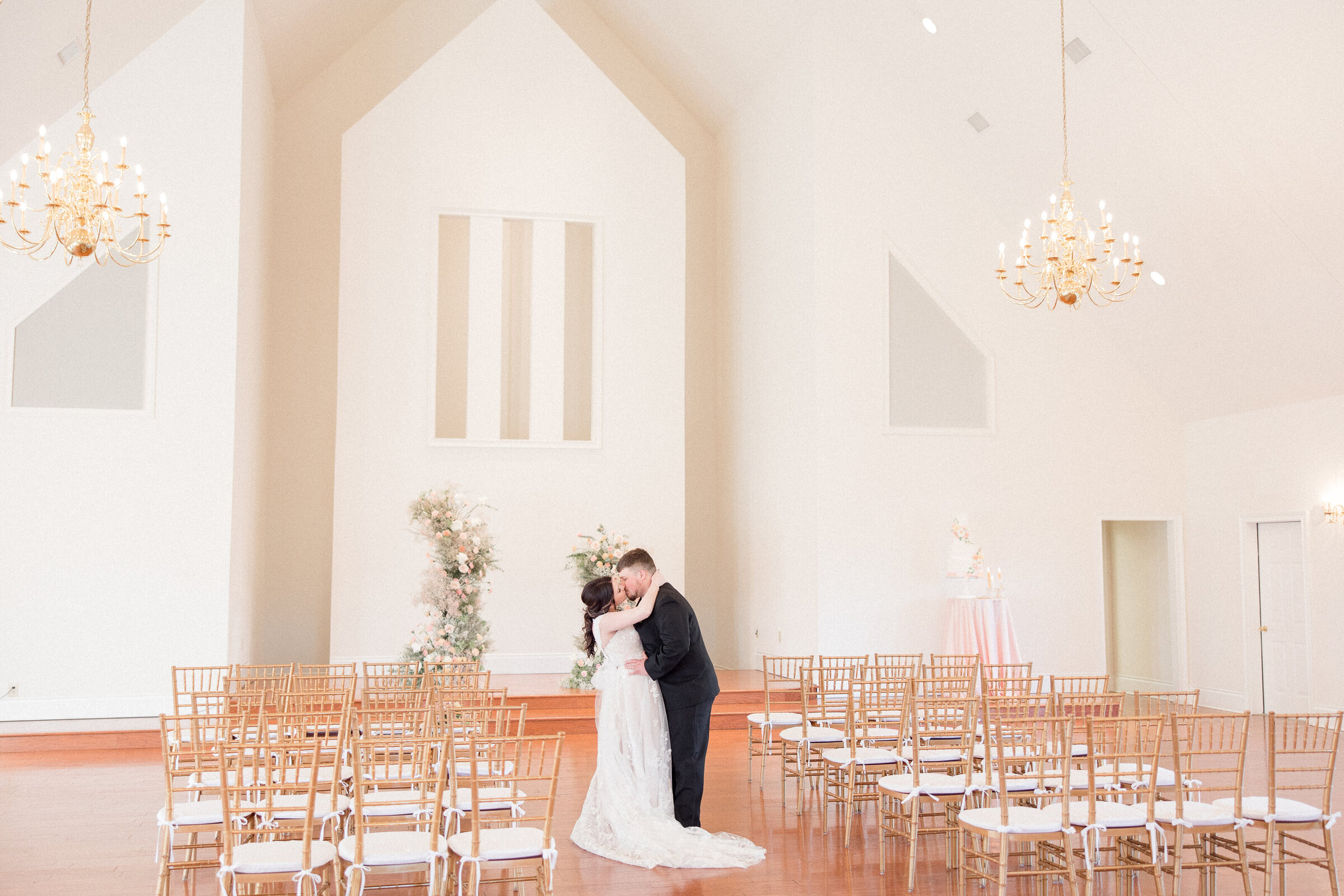 bride and groom kissing in ceremony space