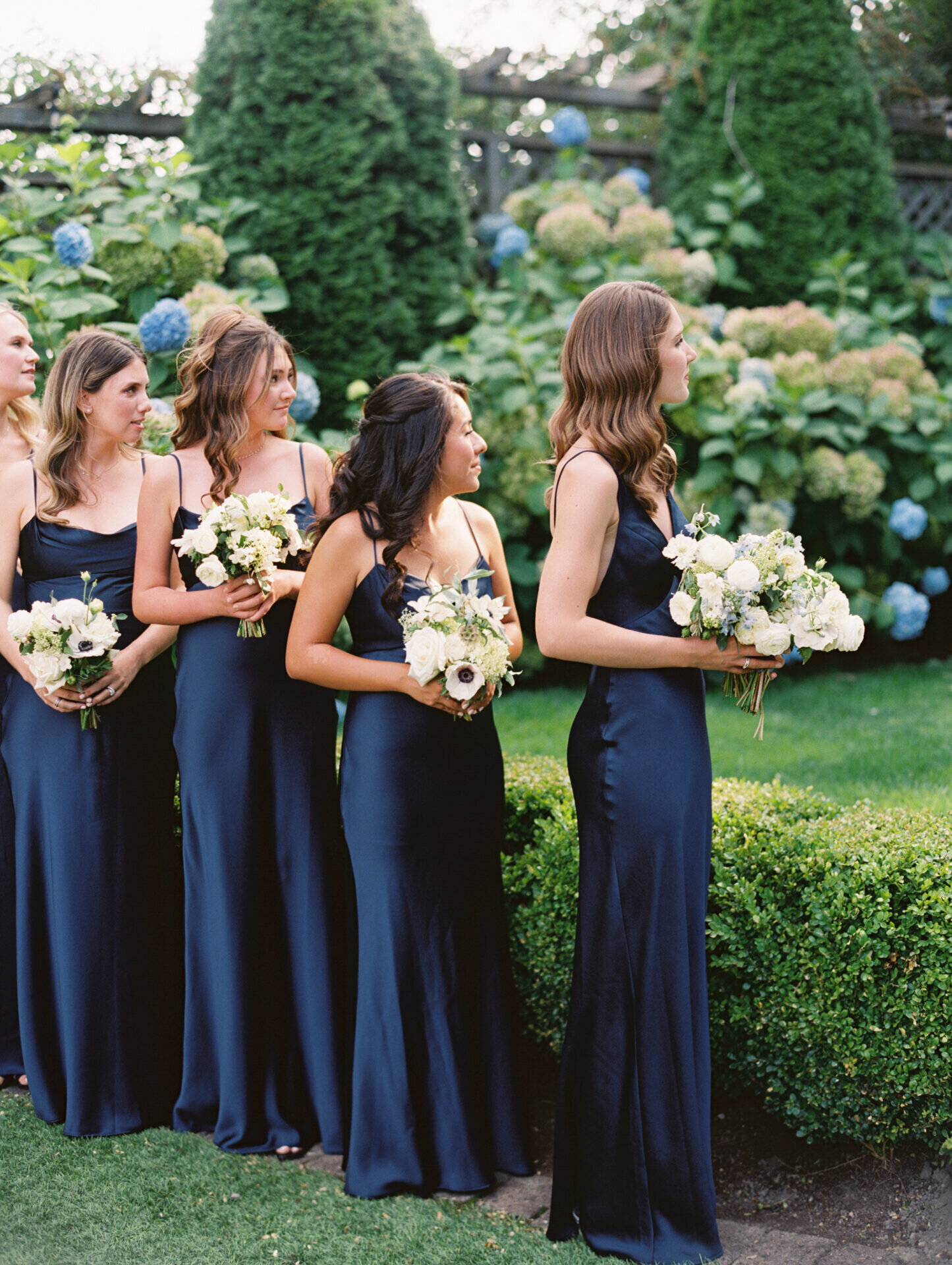 navy blue satin bridesmaid dresses with garden background