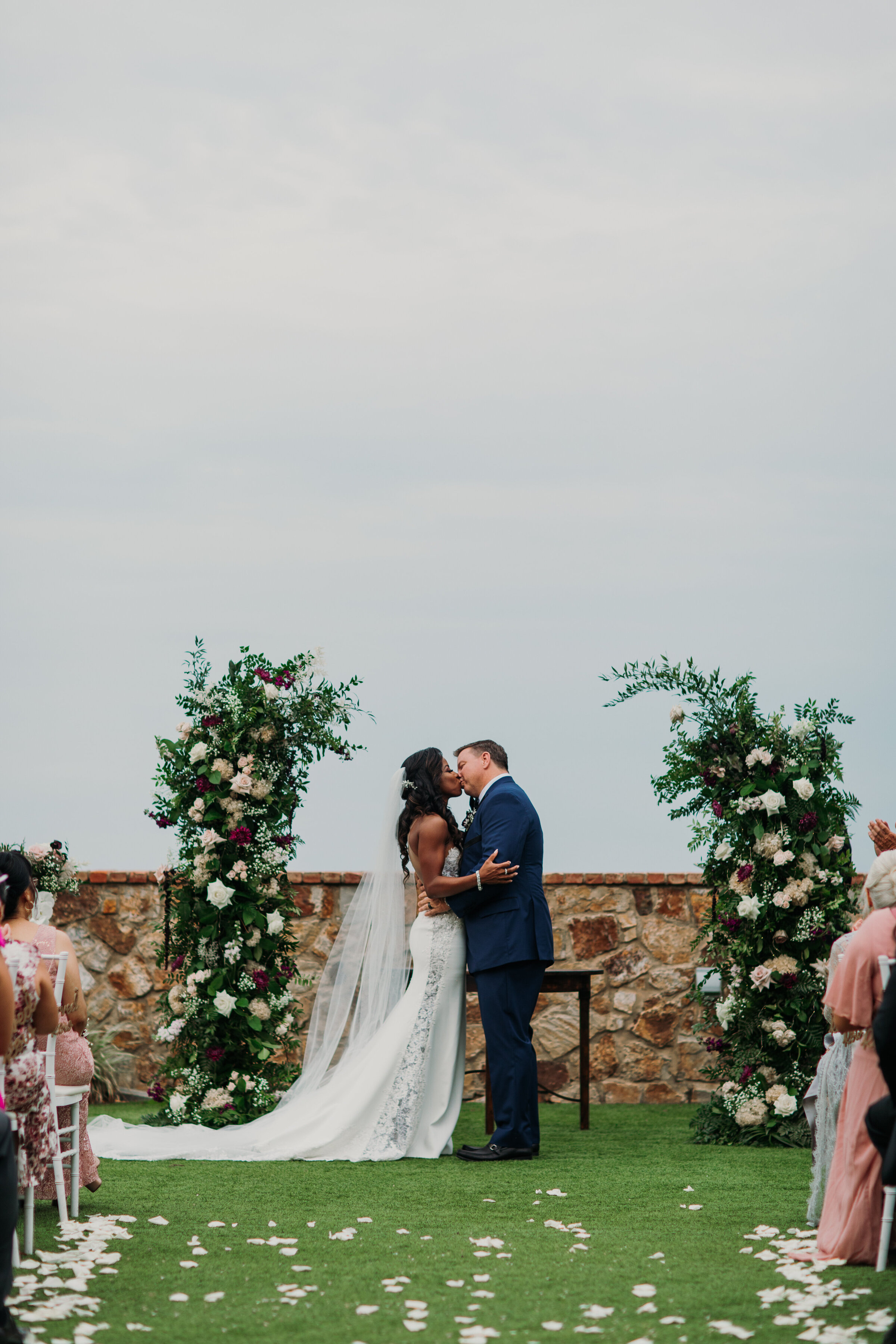 New bride and groom first kiss at bella collina