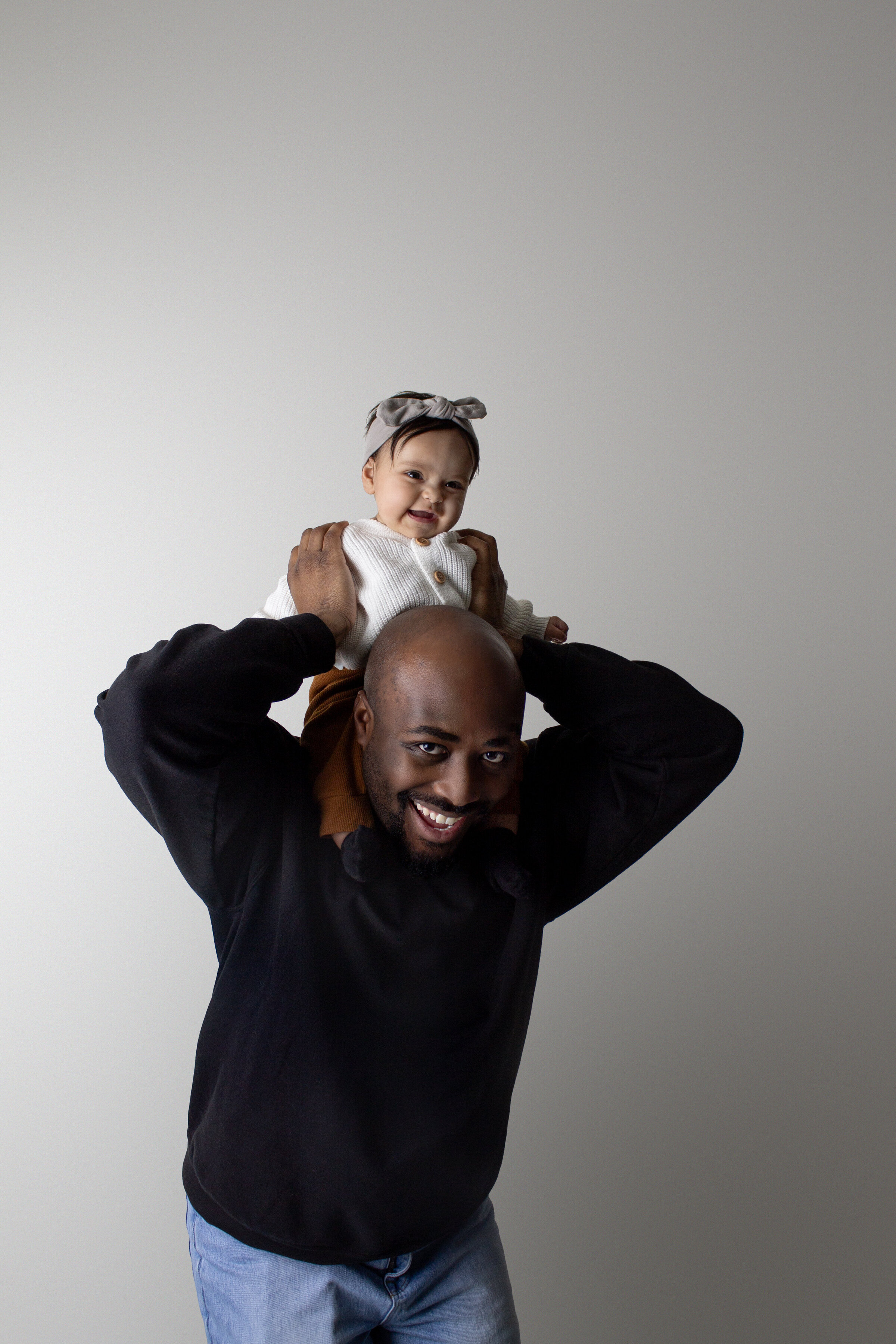 Family session of dad with his baby on his shoulders at their home  in Minot AFB, ND