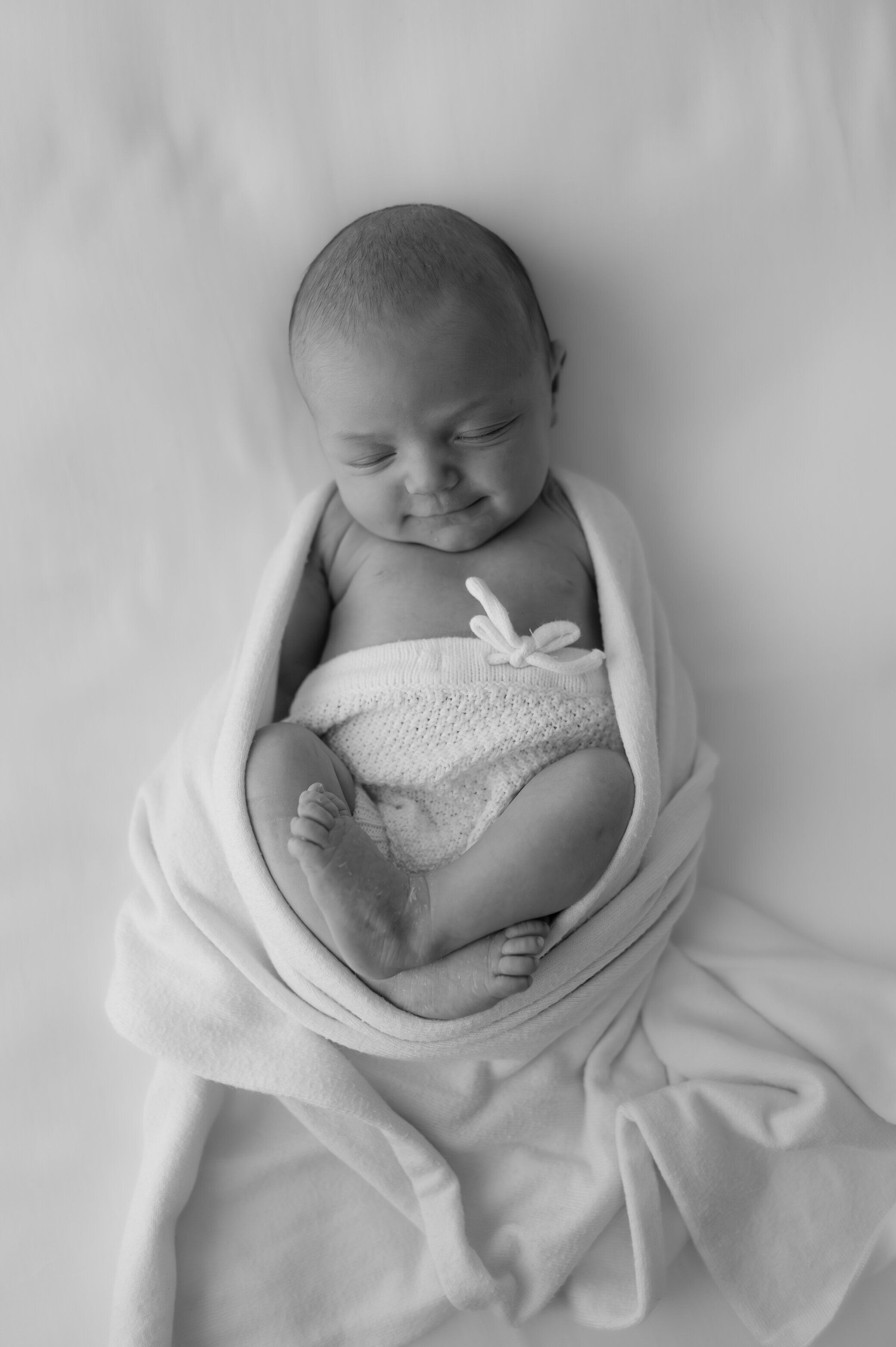 newborn baby girl smiling