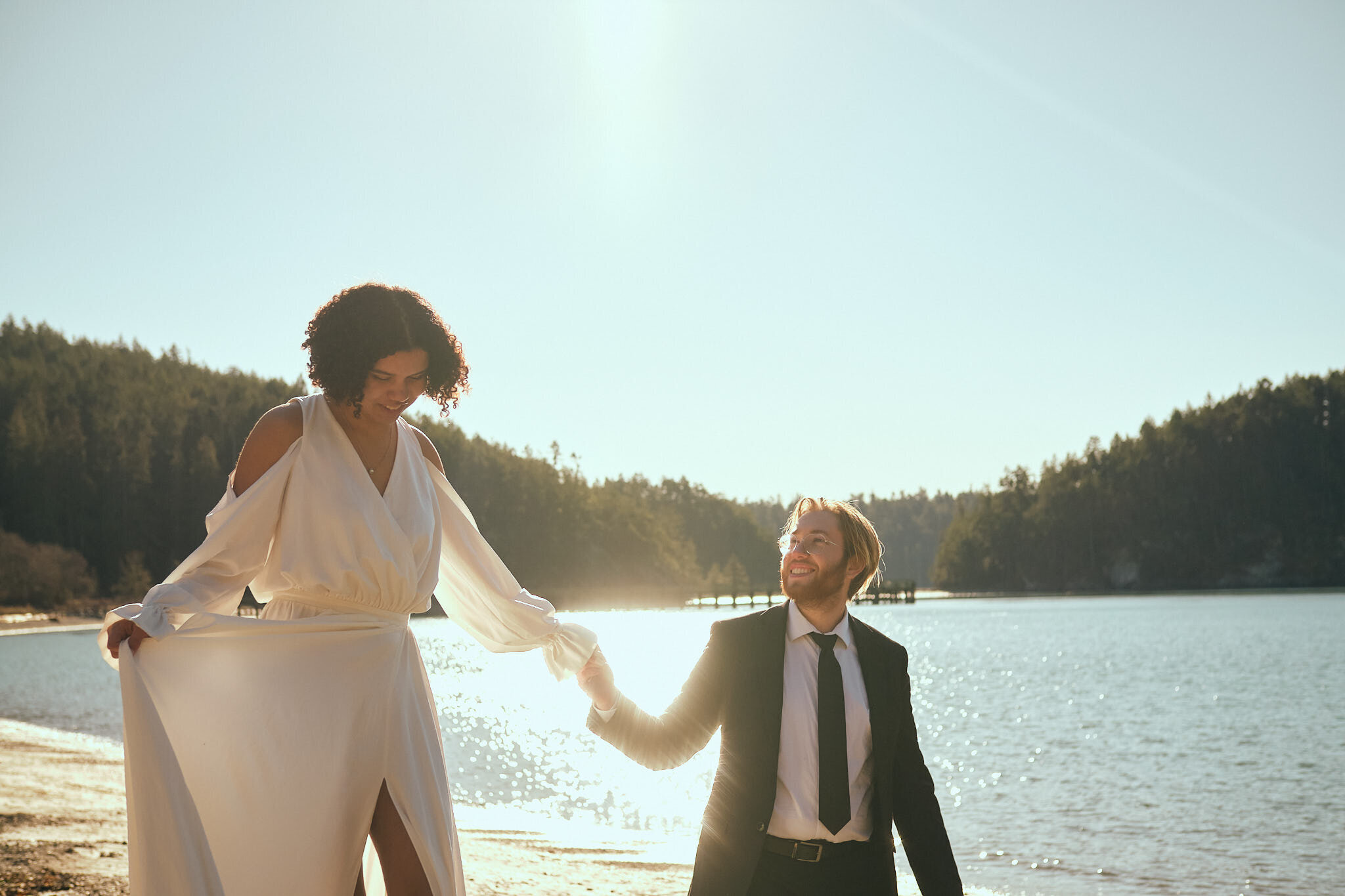 bride and groom walk on the beach at their elopement in Deception Pass