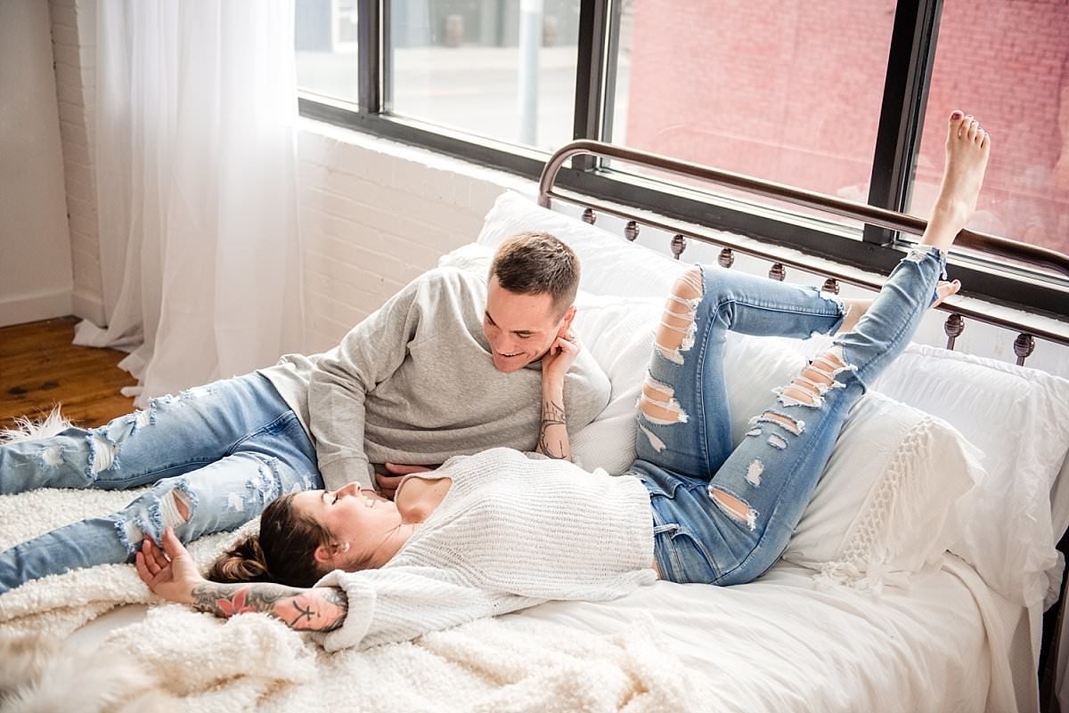 Couple wearing casual wear lounging together on their bed