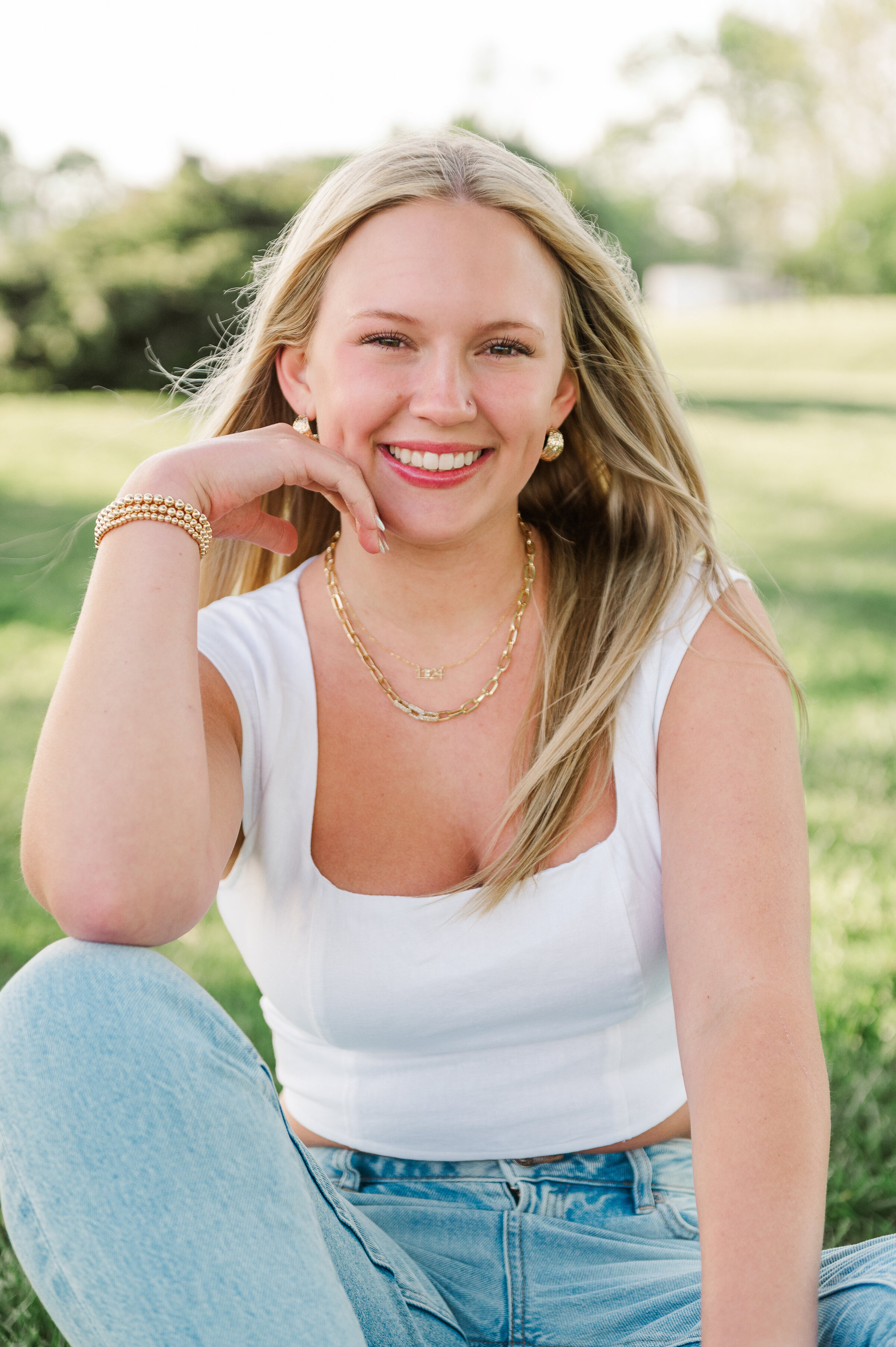 senior girl sitting in the grass by baltimore photographer