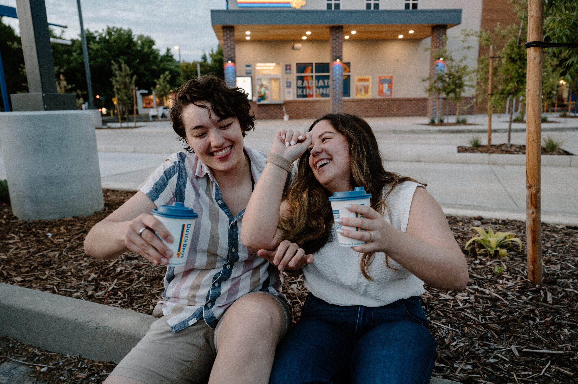 Same-sex couple enjoying coffee together after a date night