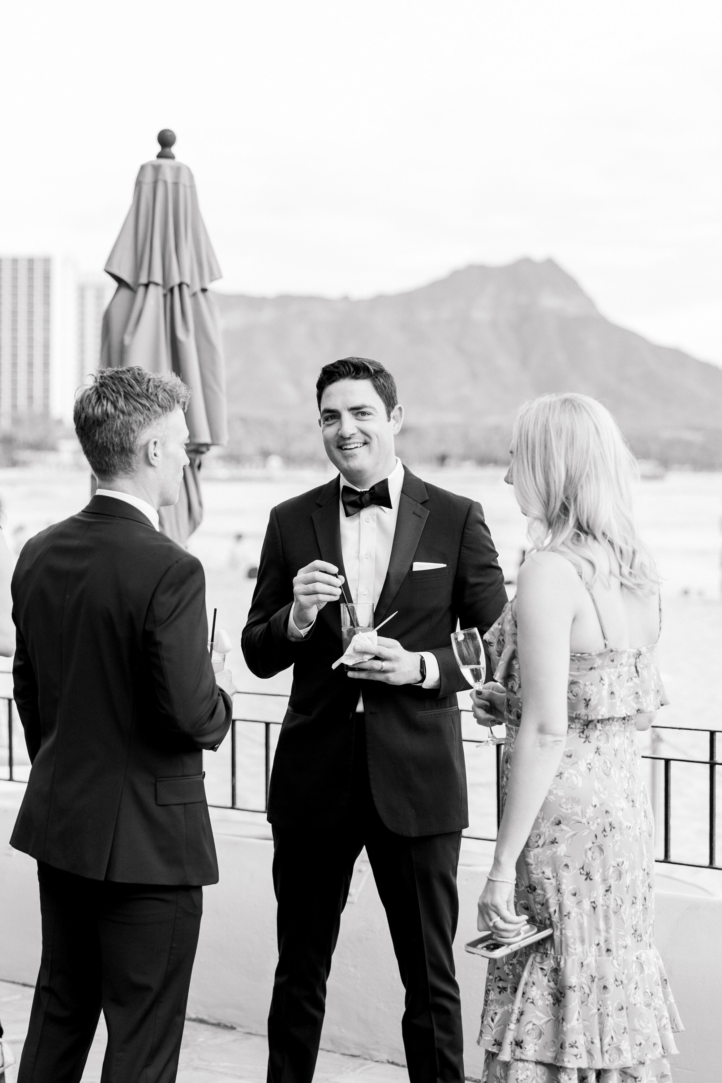 Wedding and Elopement Photographer, black and white image of groom talking with guests