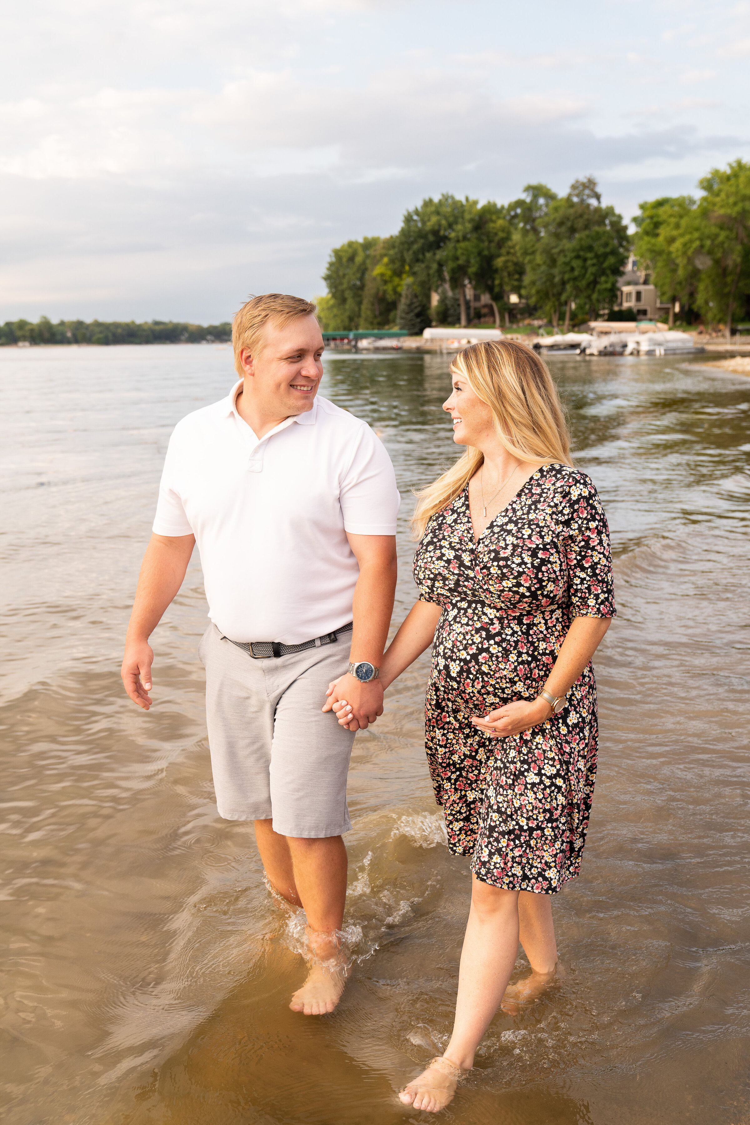 Couple walking on the beach during their maternity photo shoot in Prior Lake, Minnesota