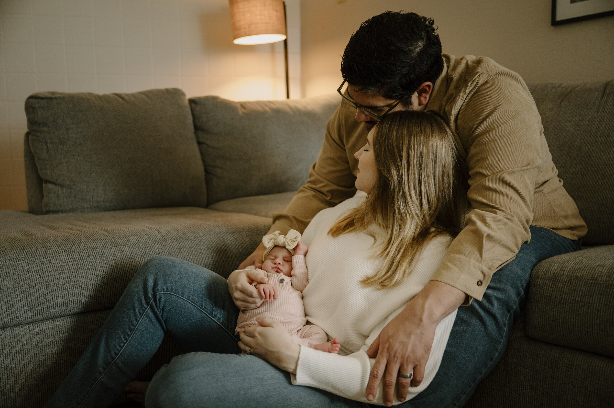 Newborn baby swaddled and sleeping peacefully during an in-home lifestyle session