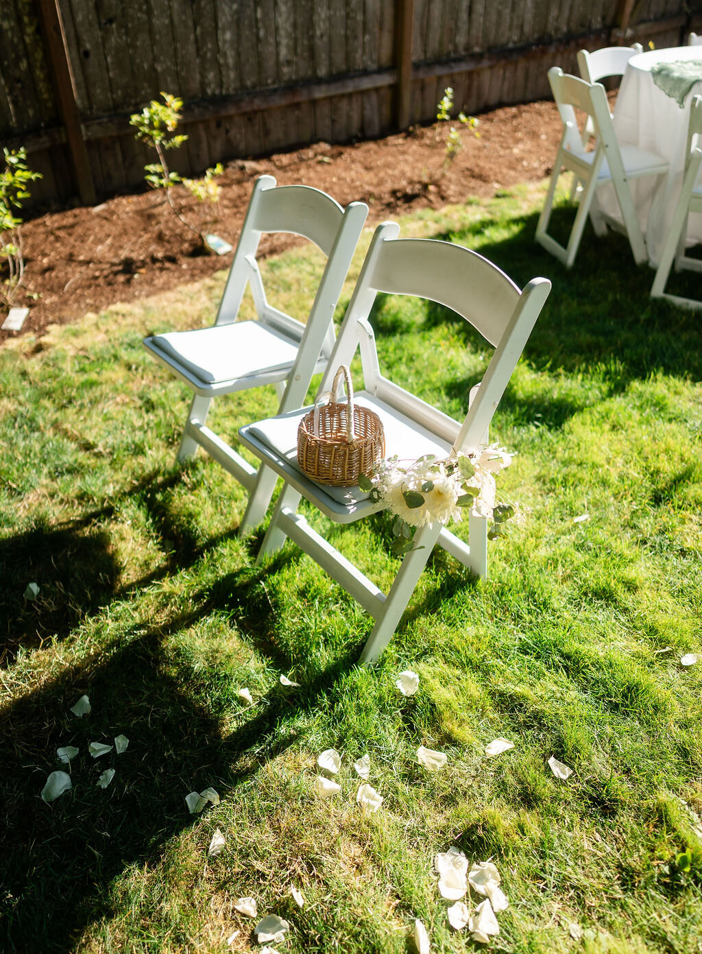detail photo of outdoor wedding ceremony chairs and flower girl basket