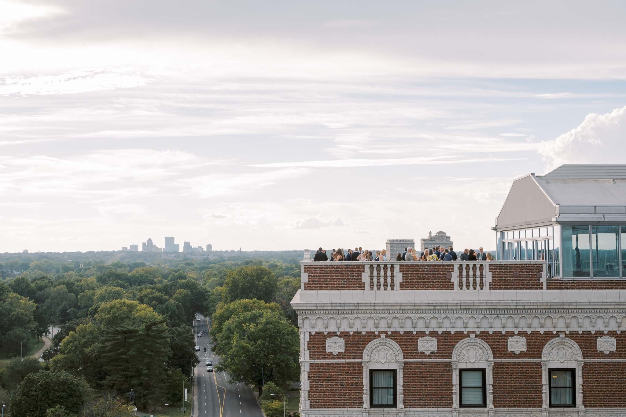 Rooftop wedding celebration overlooking a scenic city skyline