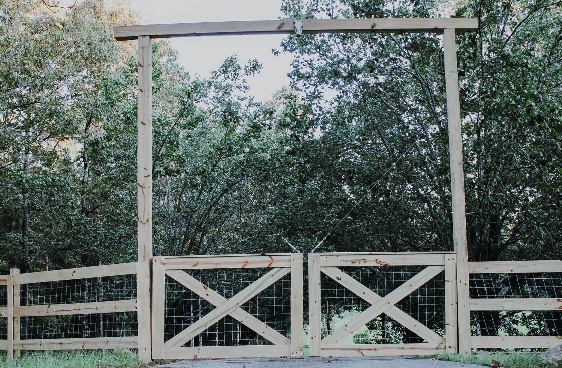 driveway-going-through-tall-wooden-entrance-gate