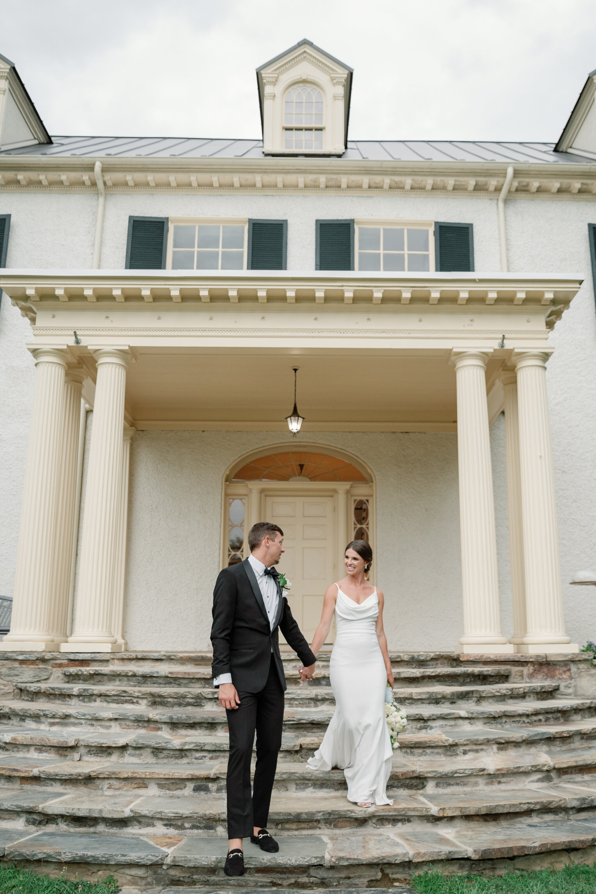 Bride and groom walking down the steps at Rust Manor House