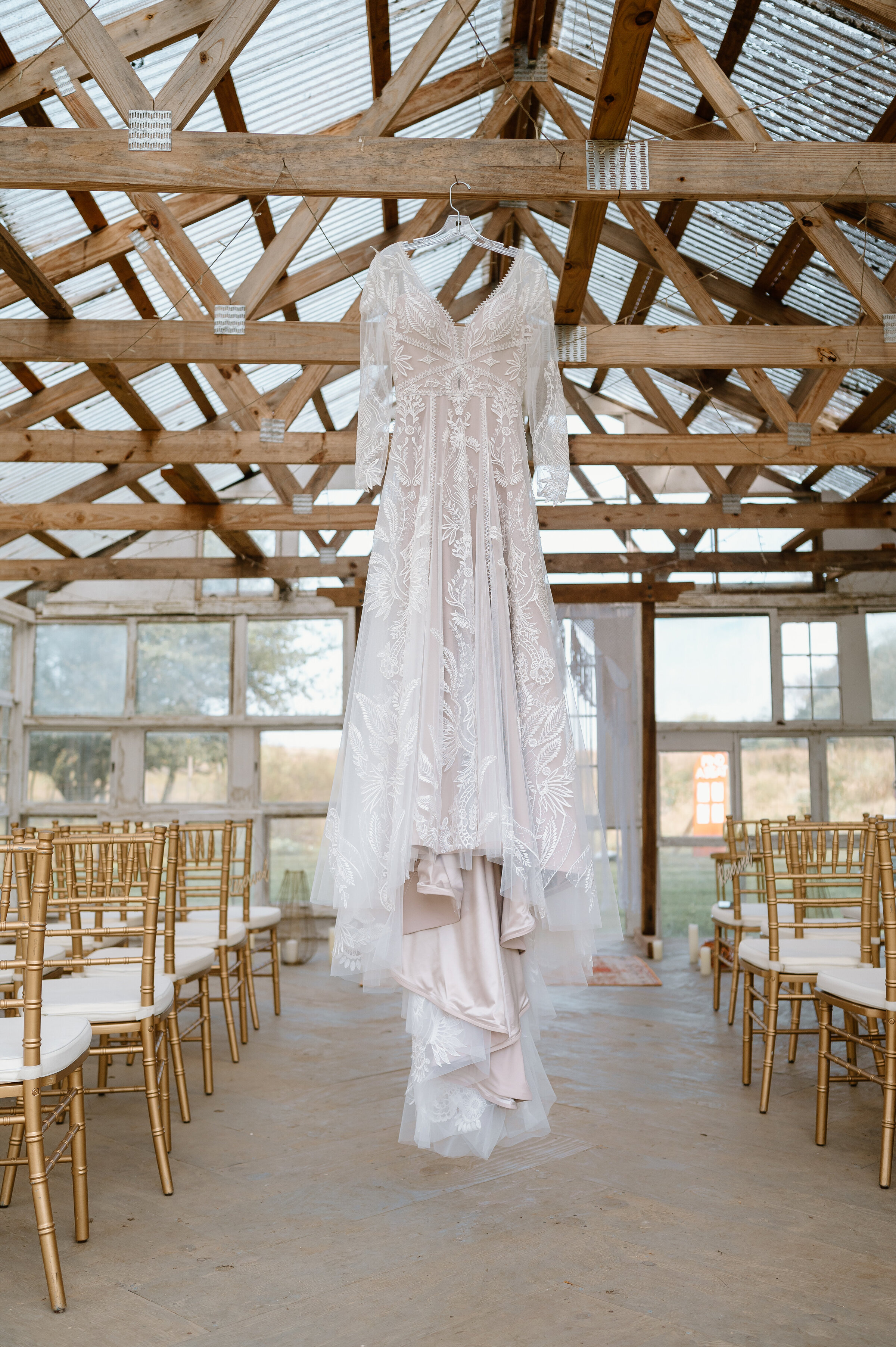 Bridal gown hanging from greenhouse