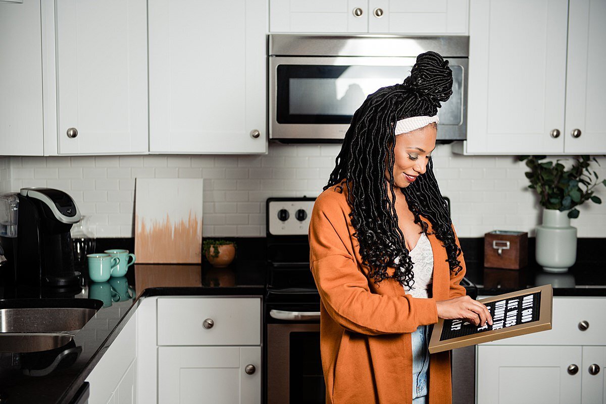 Love at Any Stage social influencer putting letters on a letterboard for inspiration in a kitchen