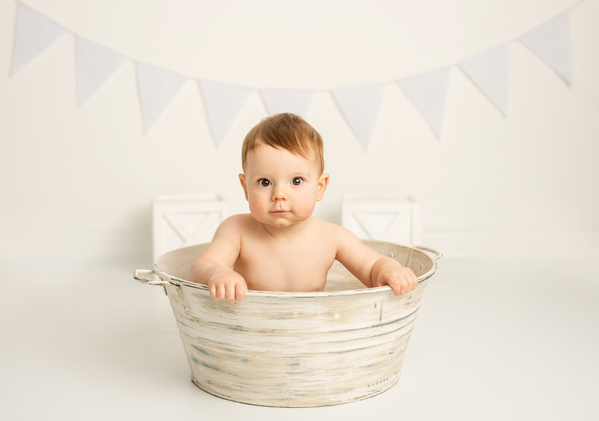 One year old baby boy in whitewash tub