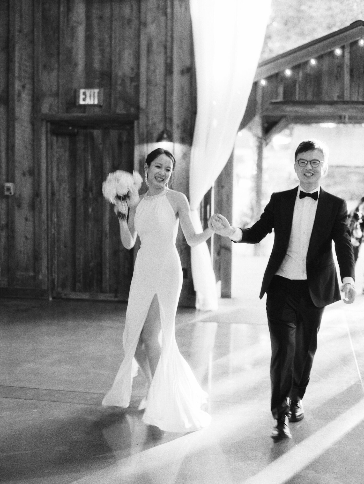 bride and groom exciting grand entrance black and white film