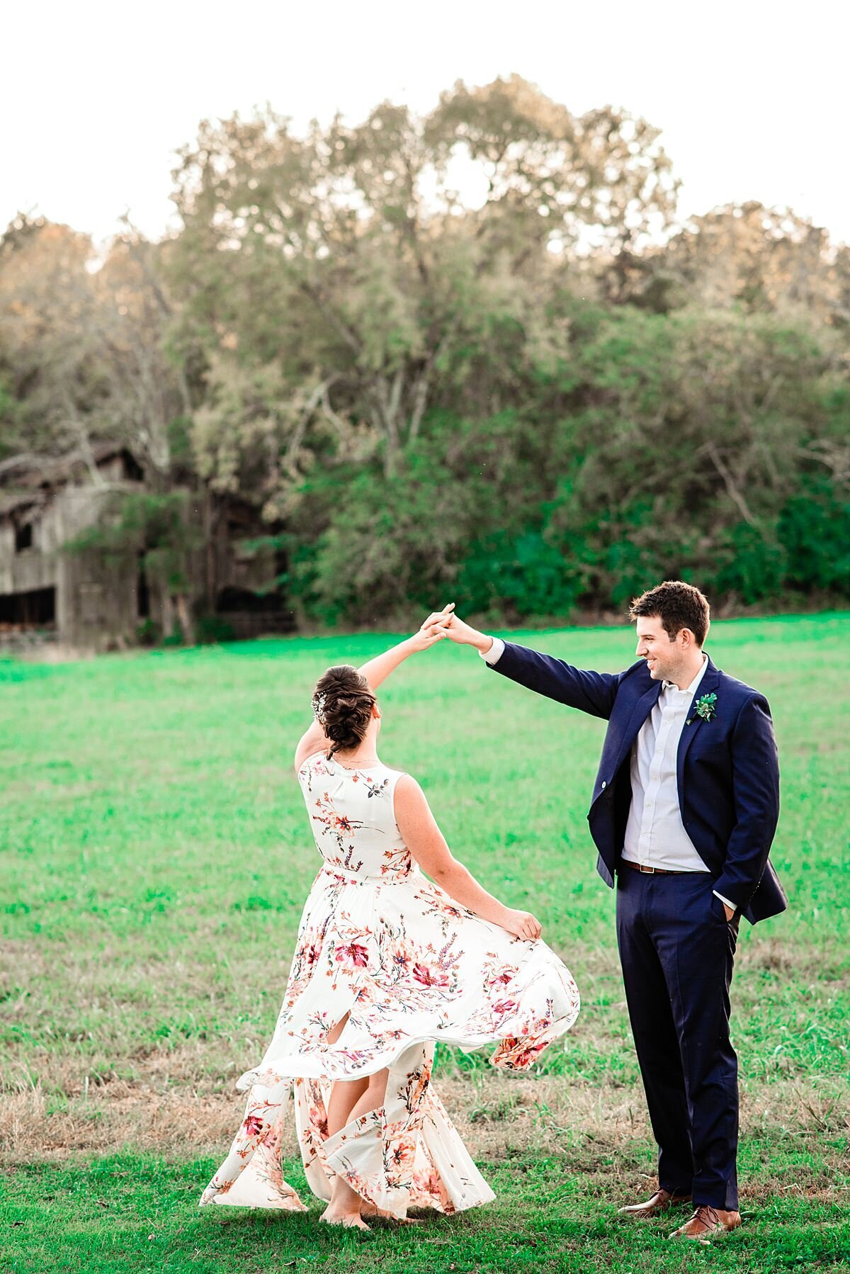 Couple twirling in celebration in a field after their Nashville elopement