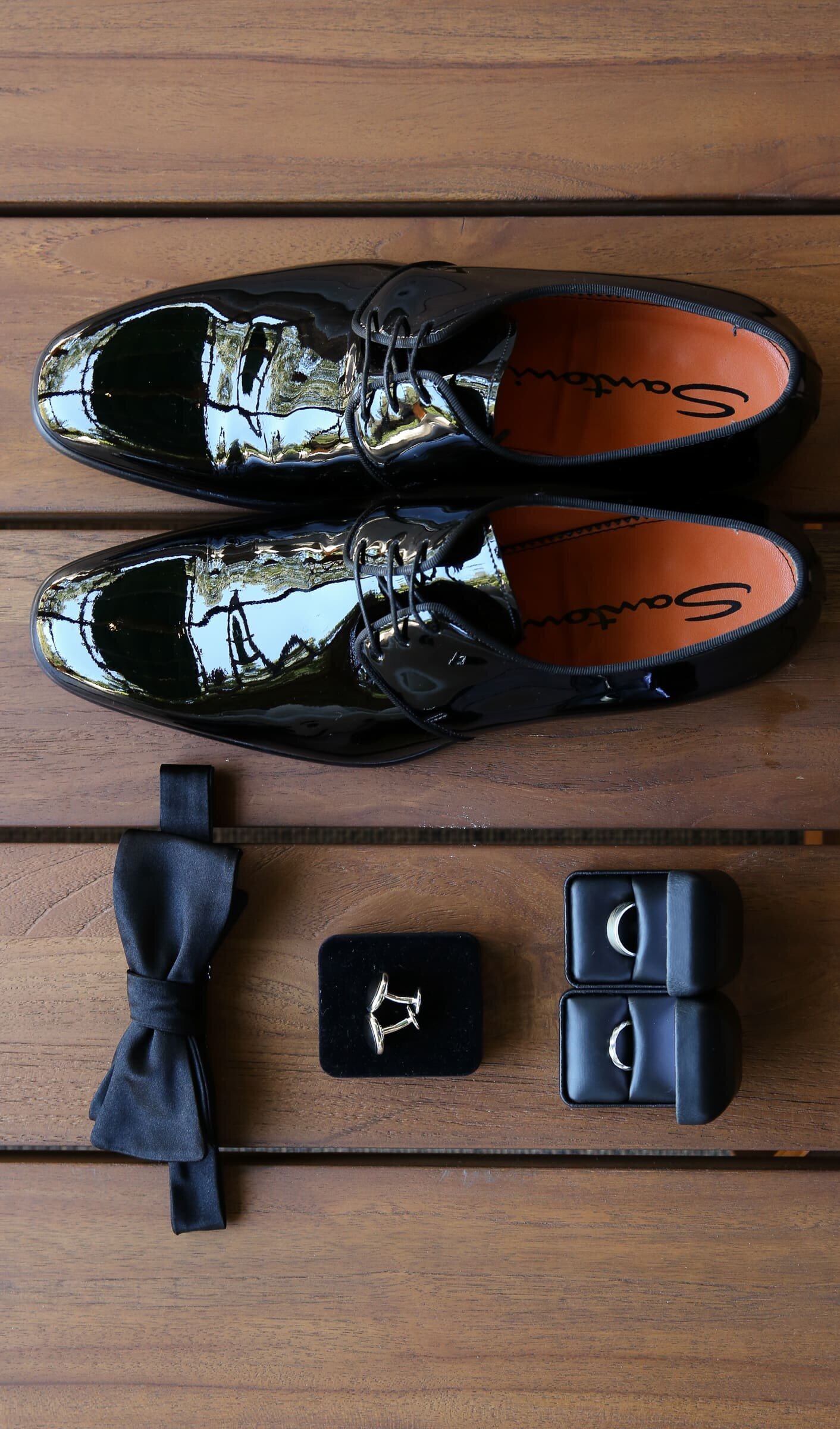 groom's accessories on a wooden floor. raleigh wedding.