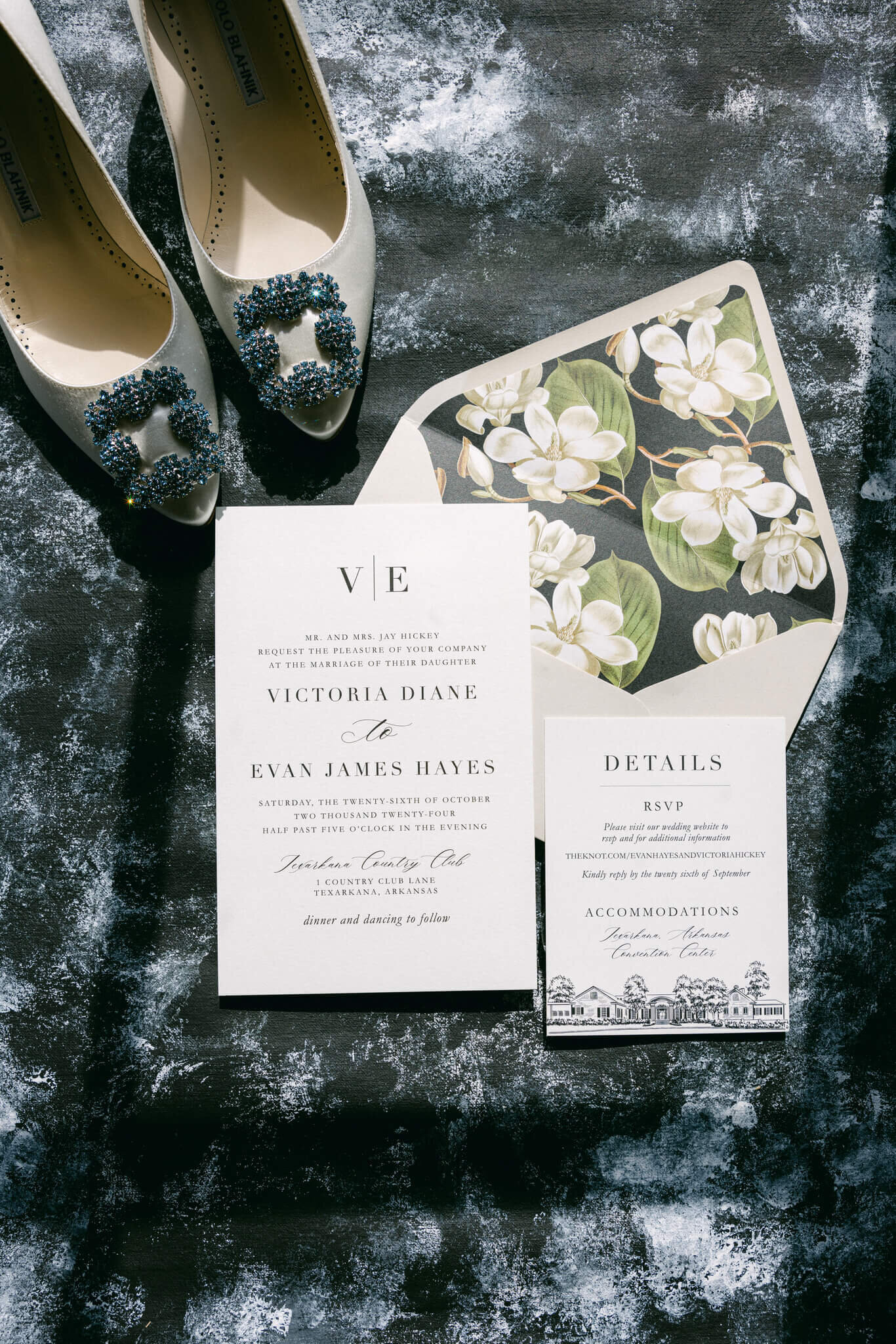 a flatlay picture of the wedding couples invitations & the brides shoes