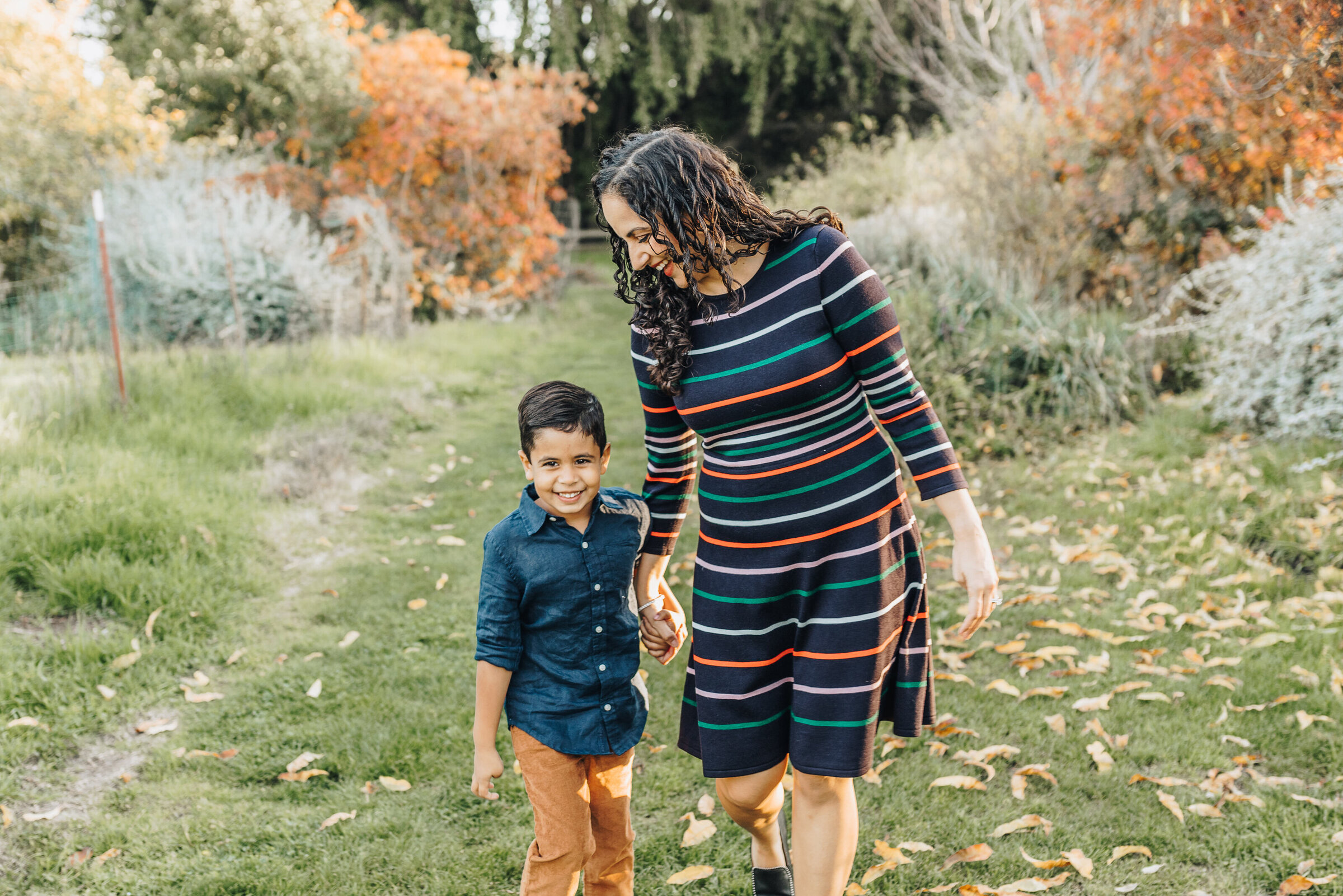 Mom walks with her son through the garden