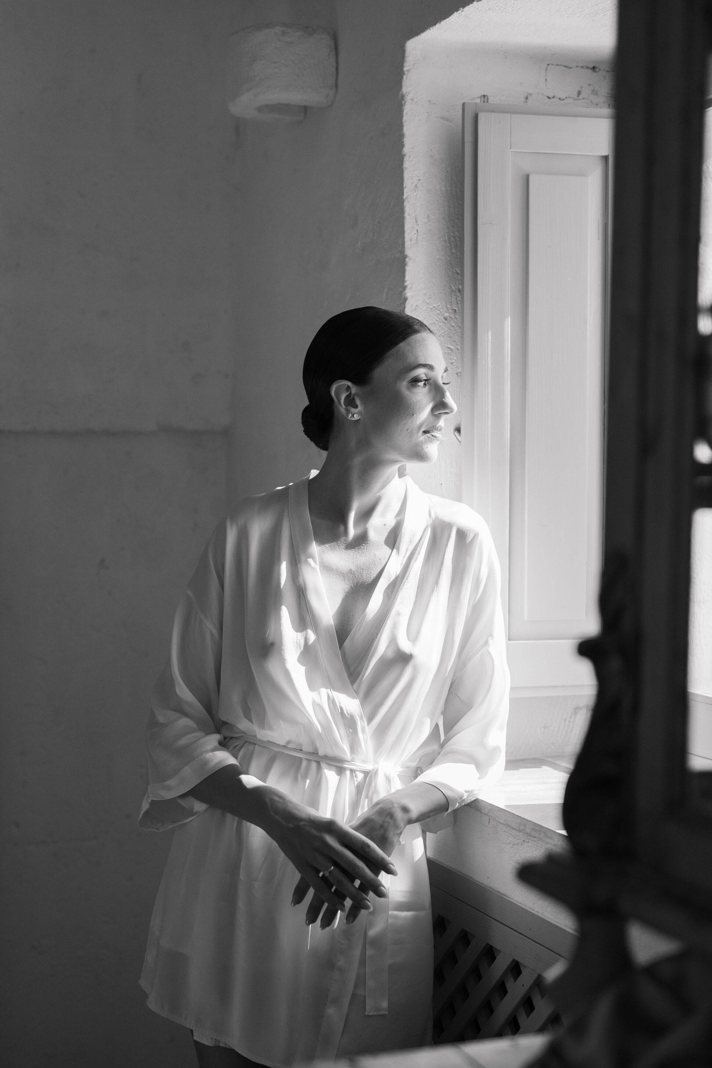 Wedding and Elopement Photographer, black and white image of bride in robe before ceremony