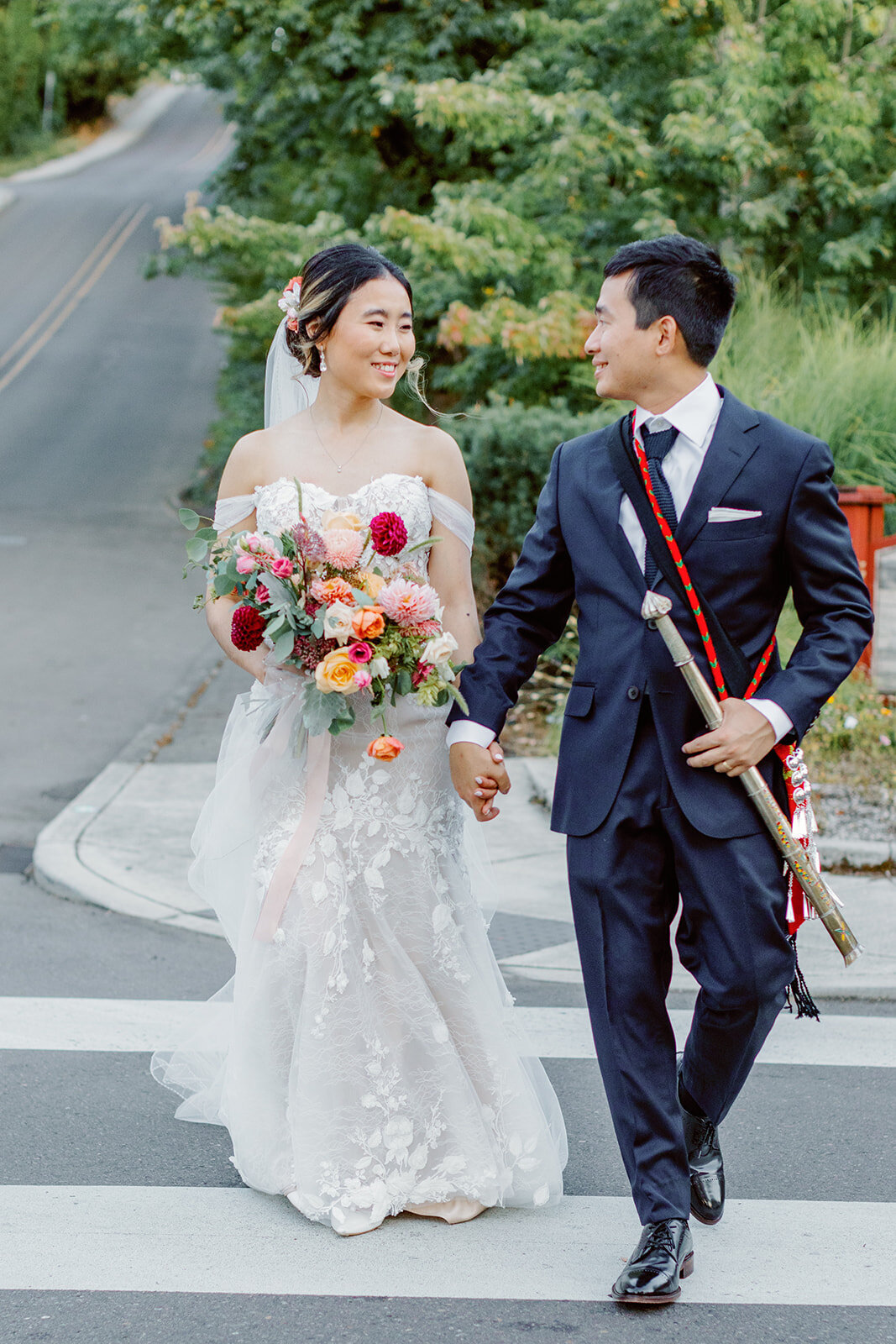 bride and groom walking down the street in Colorado Springs Colorado by Kelby Maria Photography