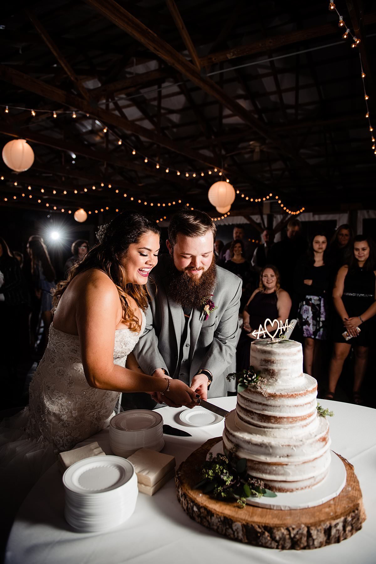 Bride and groom cutting nearly-naked cake