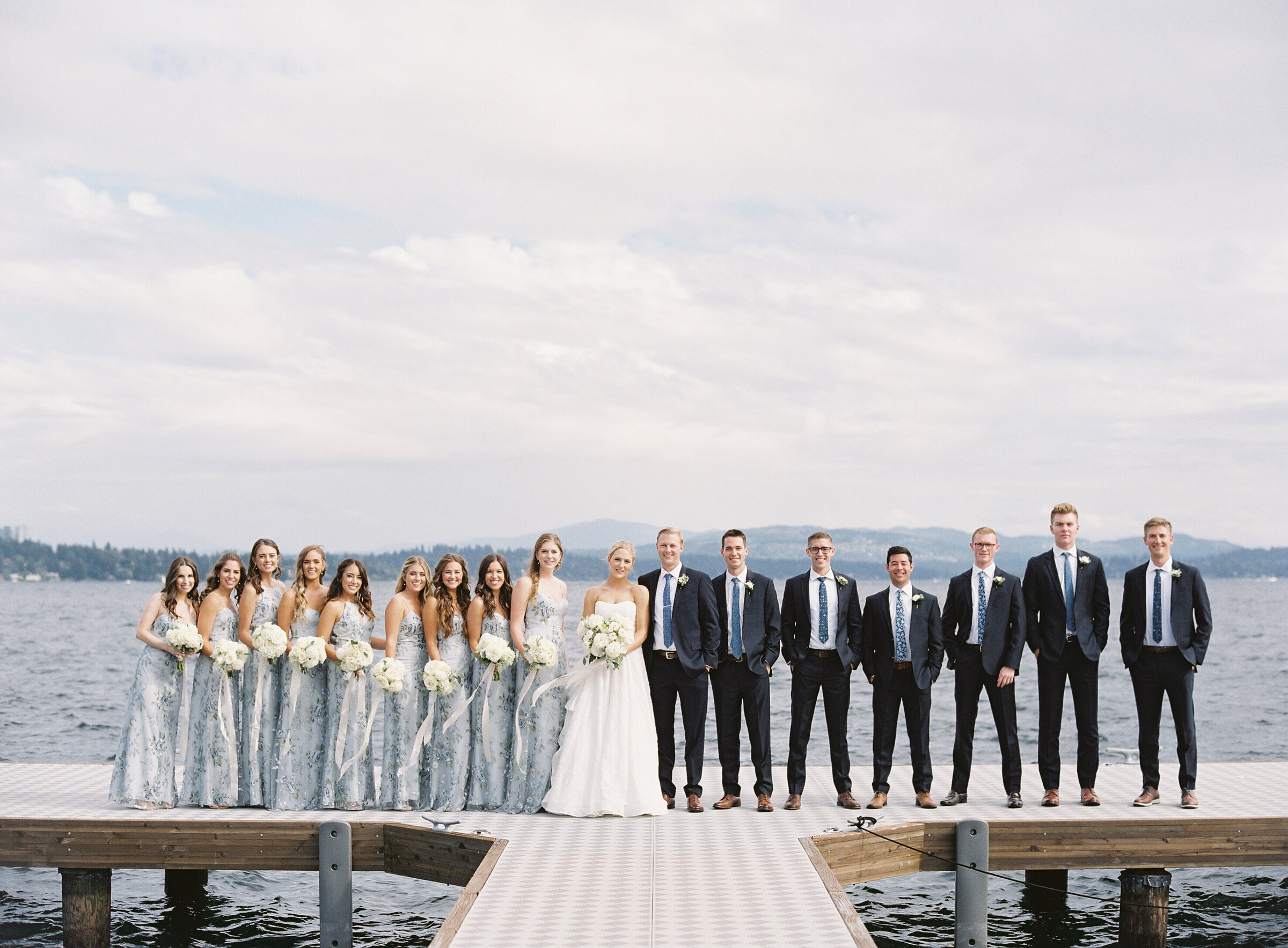 full bridal party photo on the dock overlooking the lake at seattle tennis club
