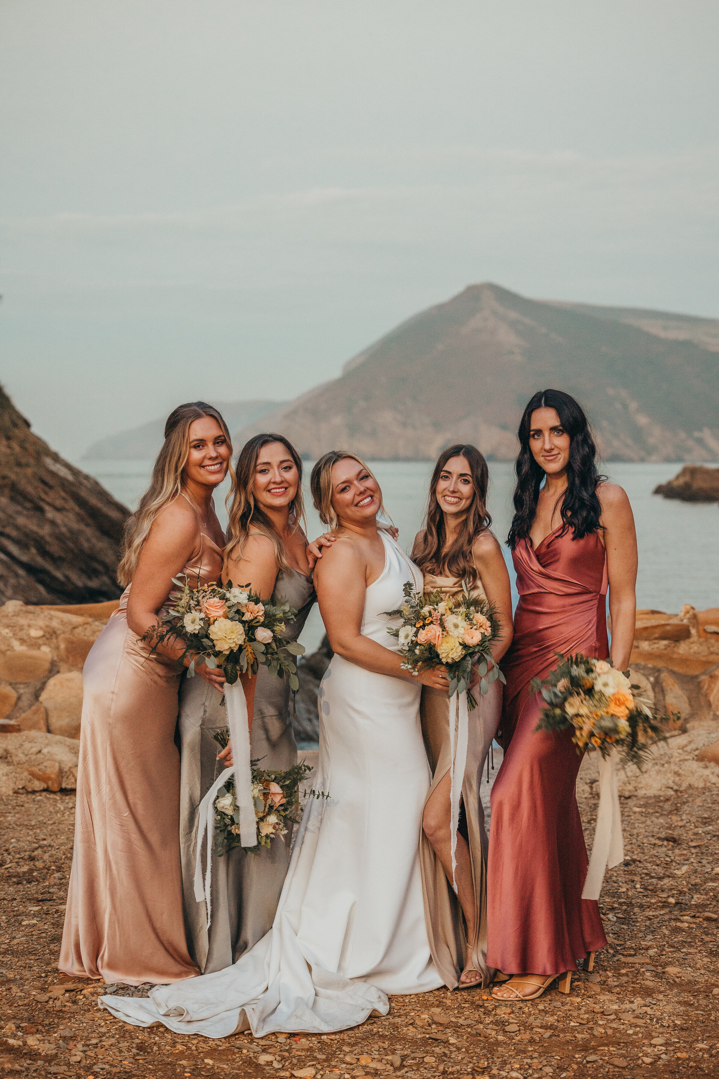 bride poses with her bridesmaids
