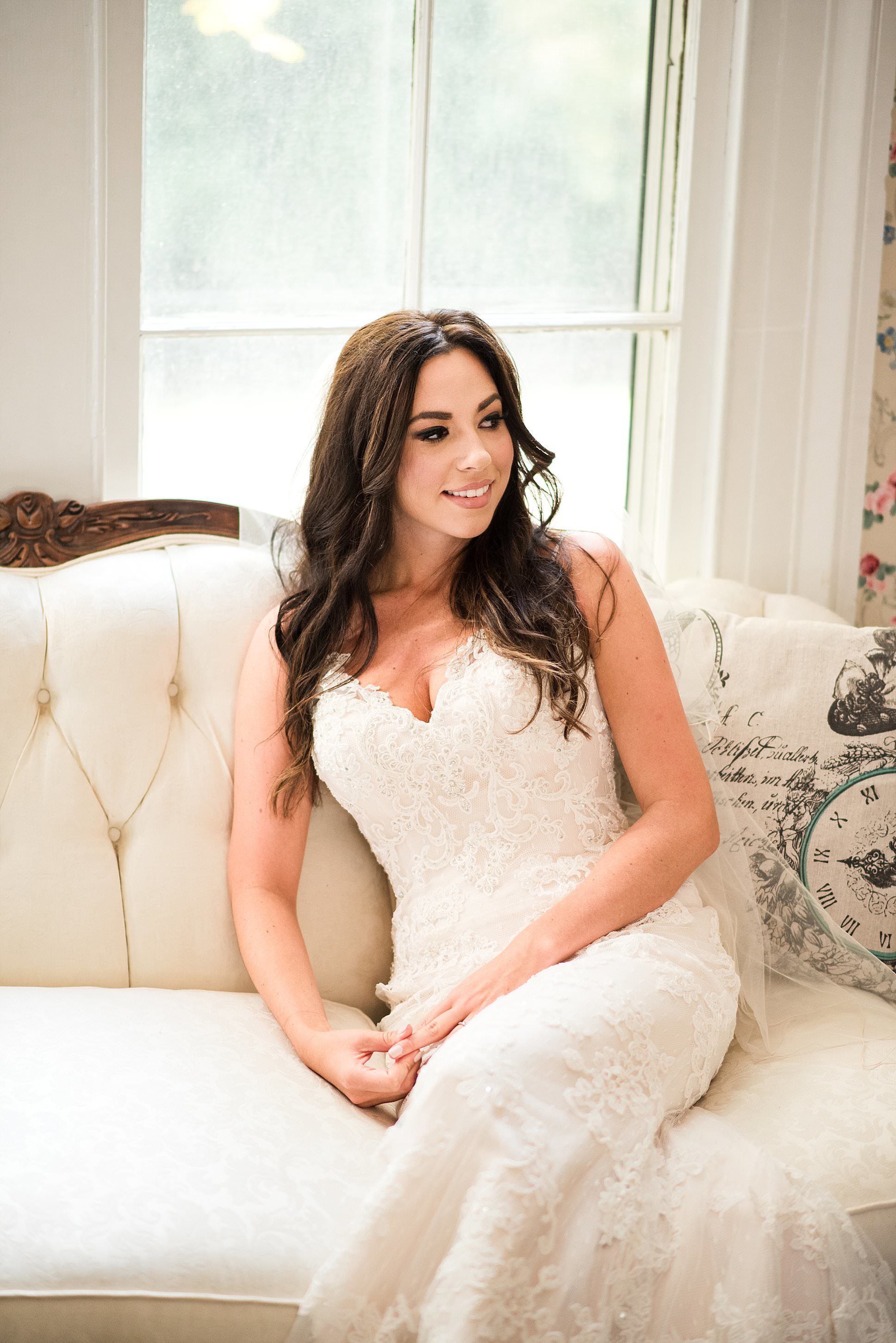 Bride lounging on a vintage couch at Drakwood Farm