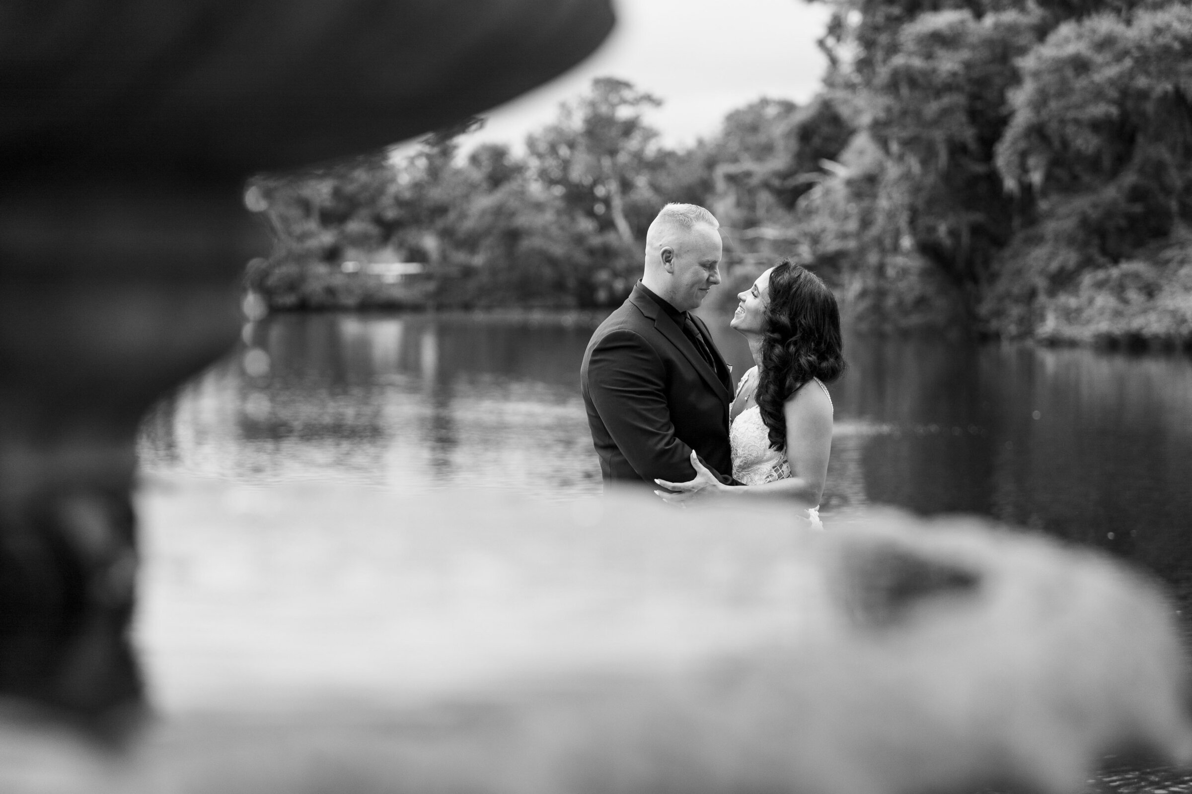 "Newlyweds embrace by the fountain in Airlie Gardens"