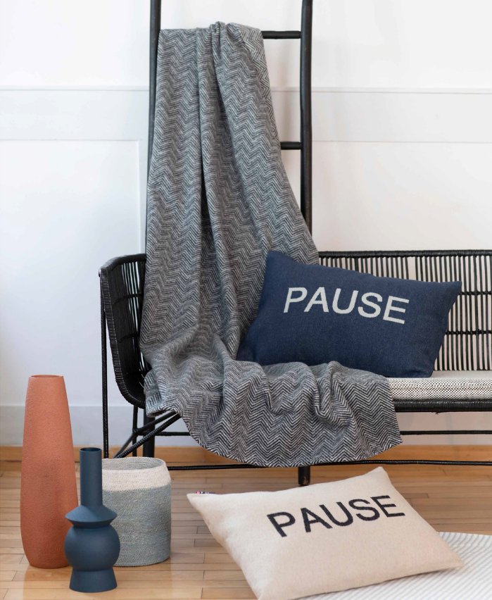 a bench with throw pillows and blankets