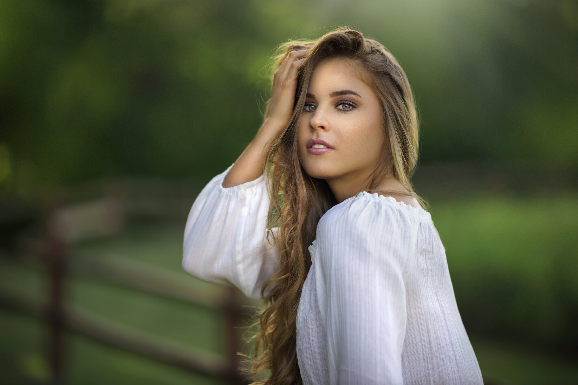Fine art portrait photograph of young woman with white blouse blonde hair with green nature background in Rockwall, Texas
