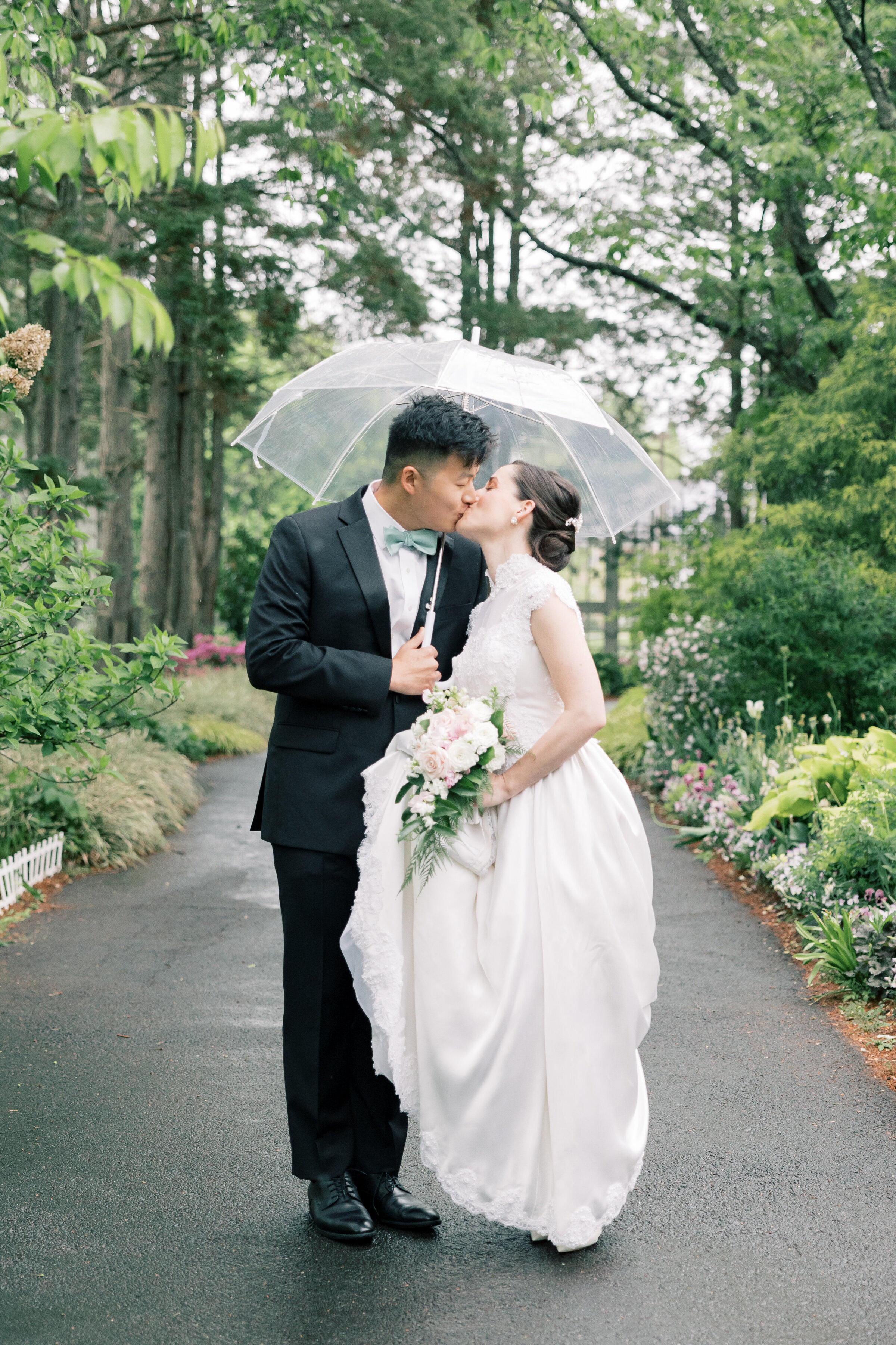 Atlanta Wedding Photographer | Bride And Groom Kissing While Holding An Umbrella At Meadowlark Botanical Garden Wedding