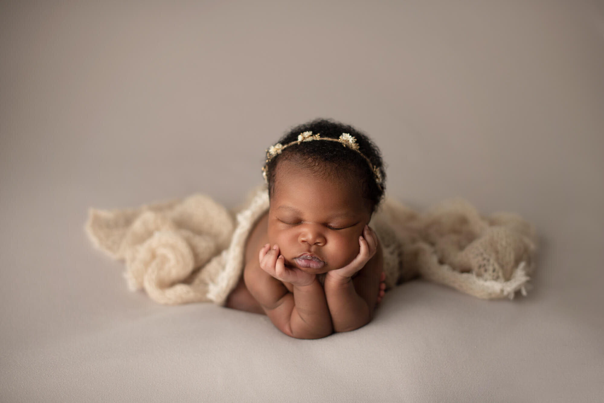 Baby girl in froggy pose with floral halo