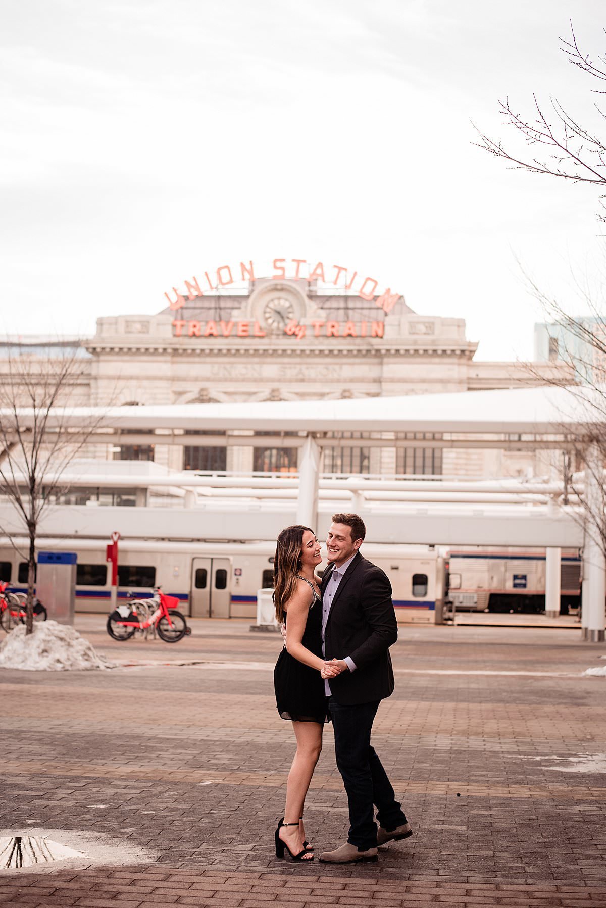 Couple dancing together with Union Station Denver in background