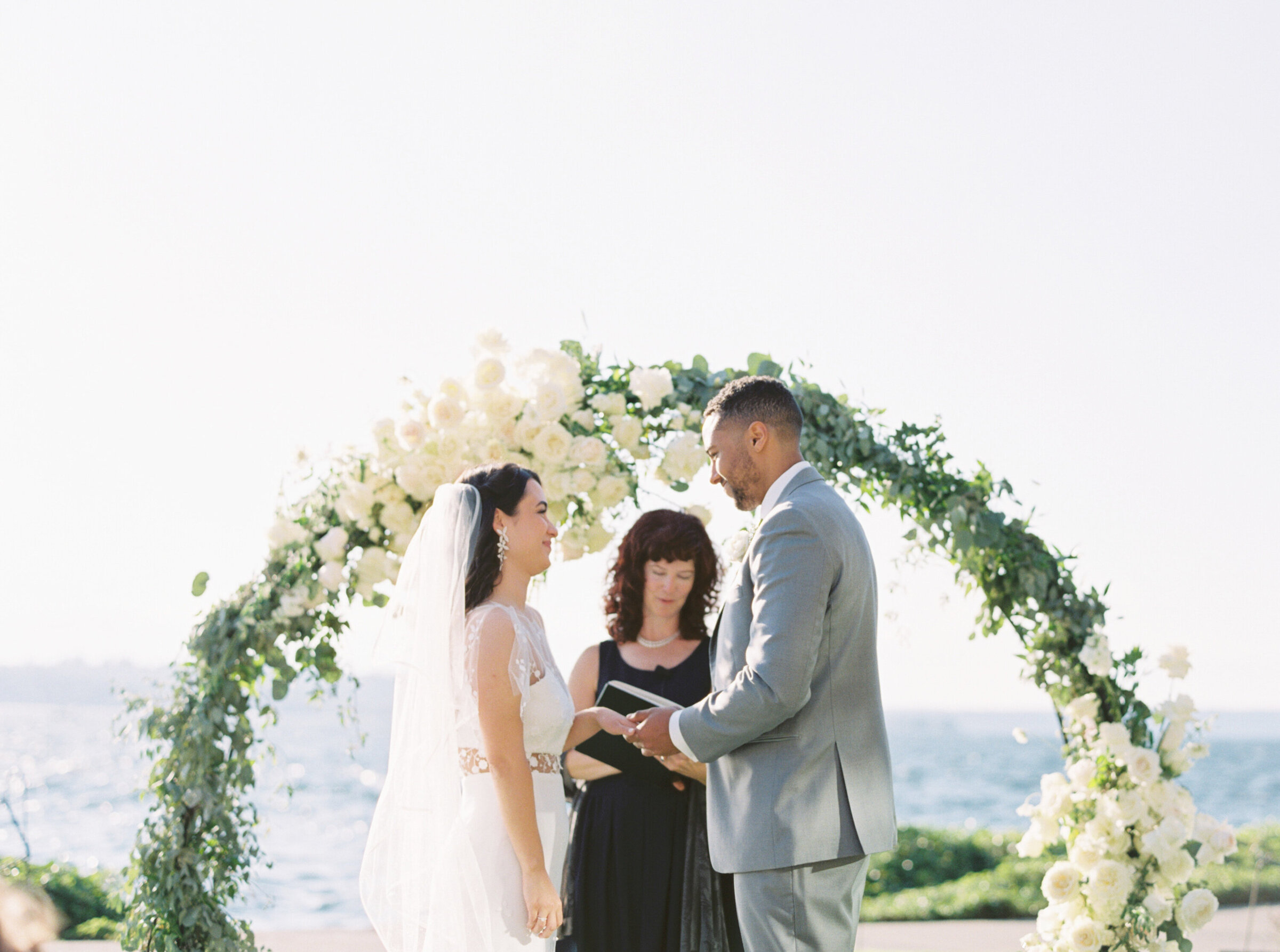 bride and groom at the alter outdoors lakeside at wedding ceremony