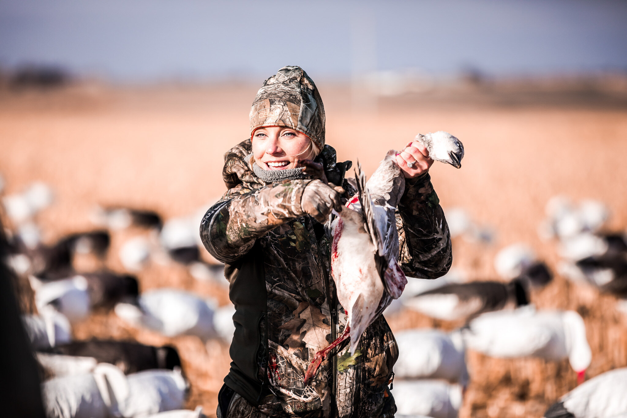 Kansas waterfowl hunter holding up a snow goose