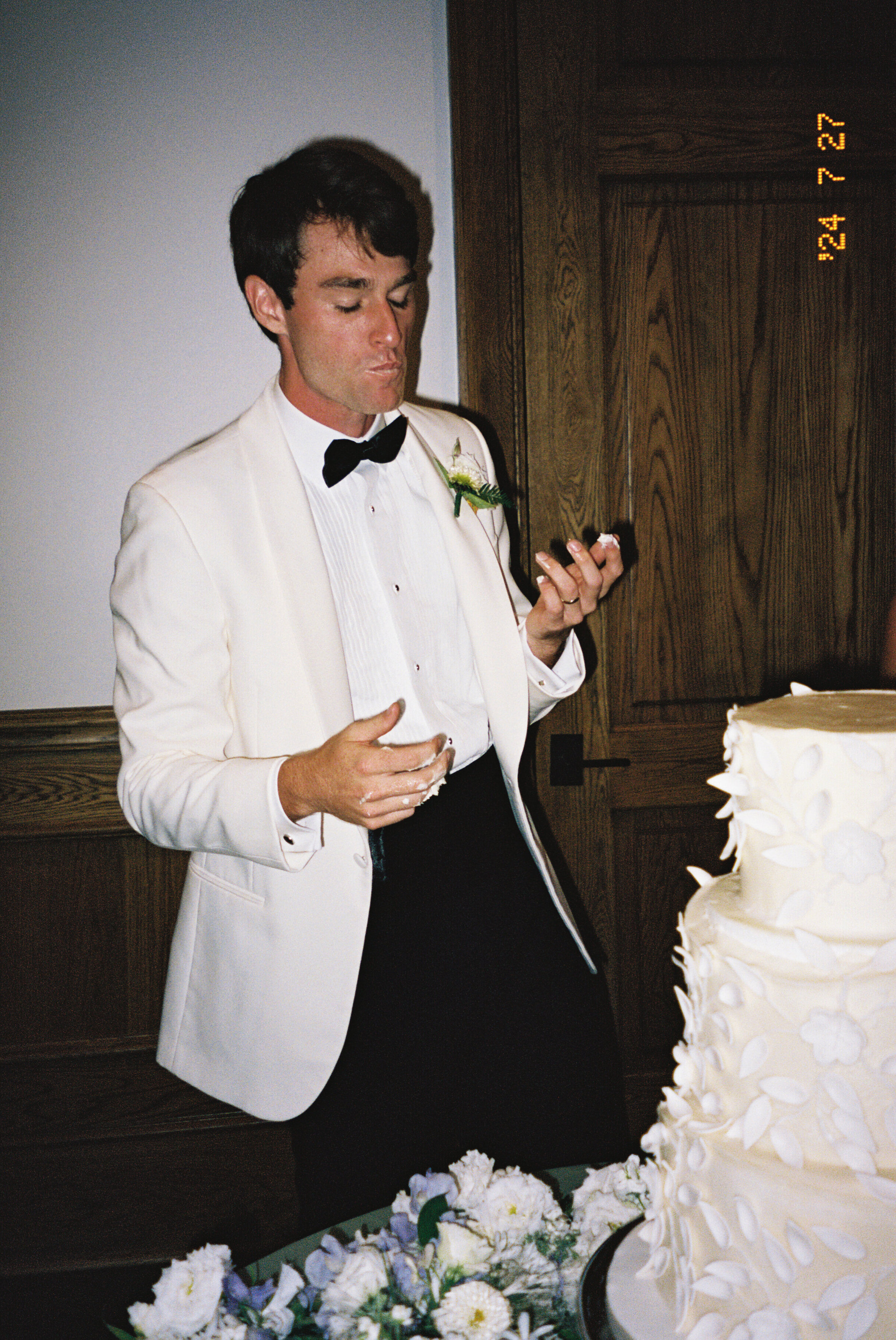 a groom eating his wedding cake on St. Simons Island