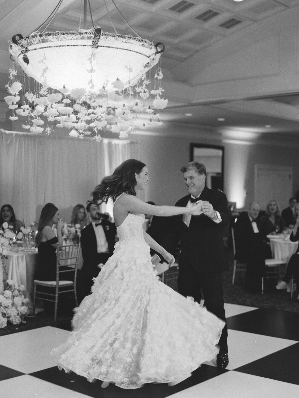 bride dancing with her dad black and white