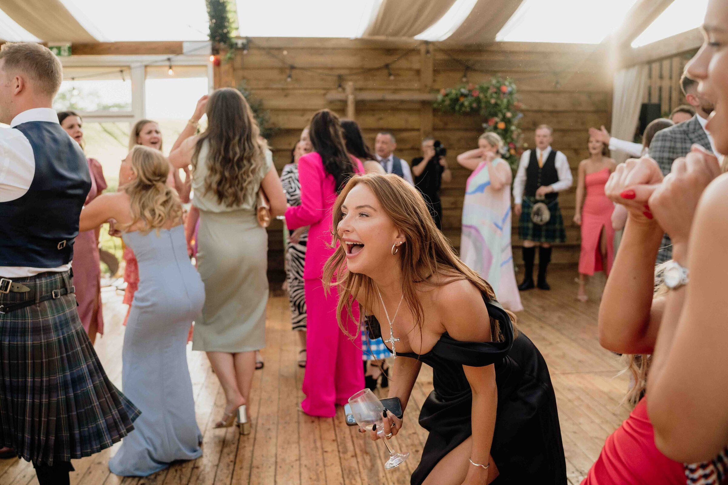 A wedding guest is photographed dancing in an Aberdeenshire barn venue.