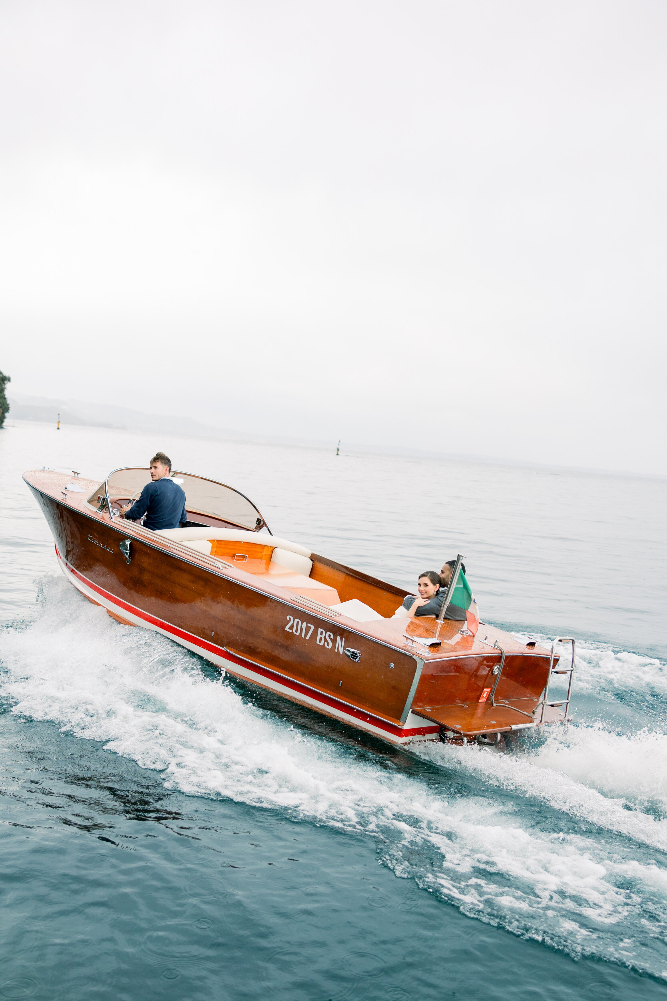 Wedding and Elopement Photographer, couple getting a ride on the back of speed boat