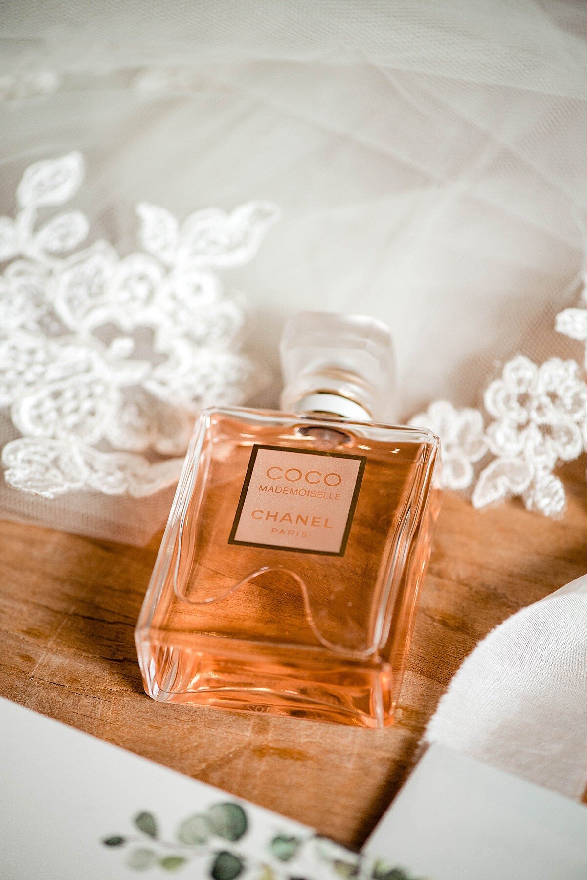 Detail photo of Coco Chanel Perfume bottle alongside wedding veil