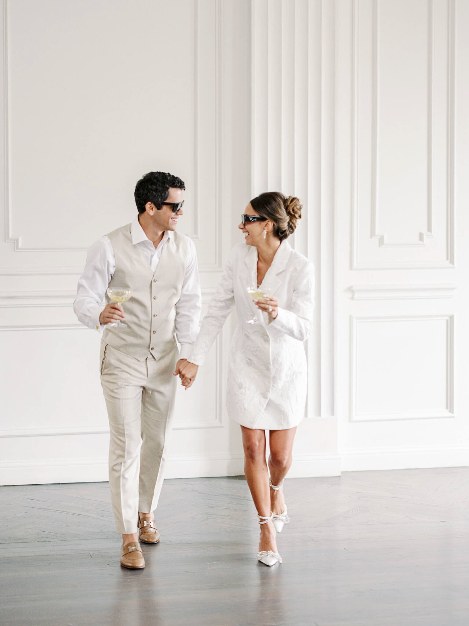 Stylish bride and groom wearing Prada sunglasses at their wedding reception