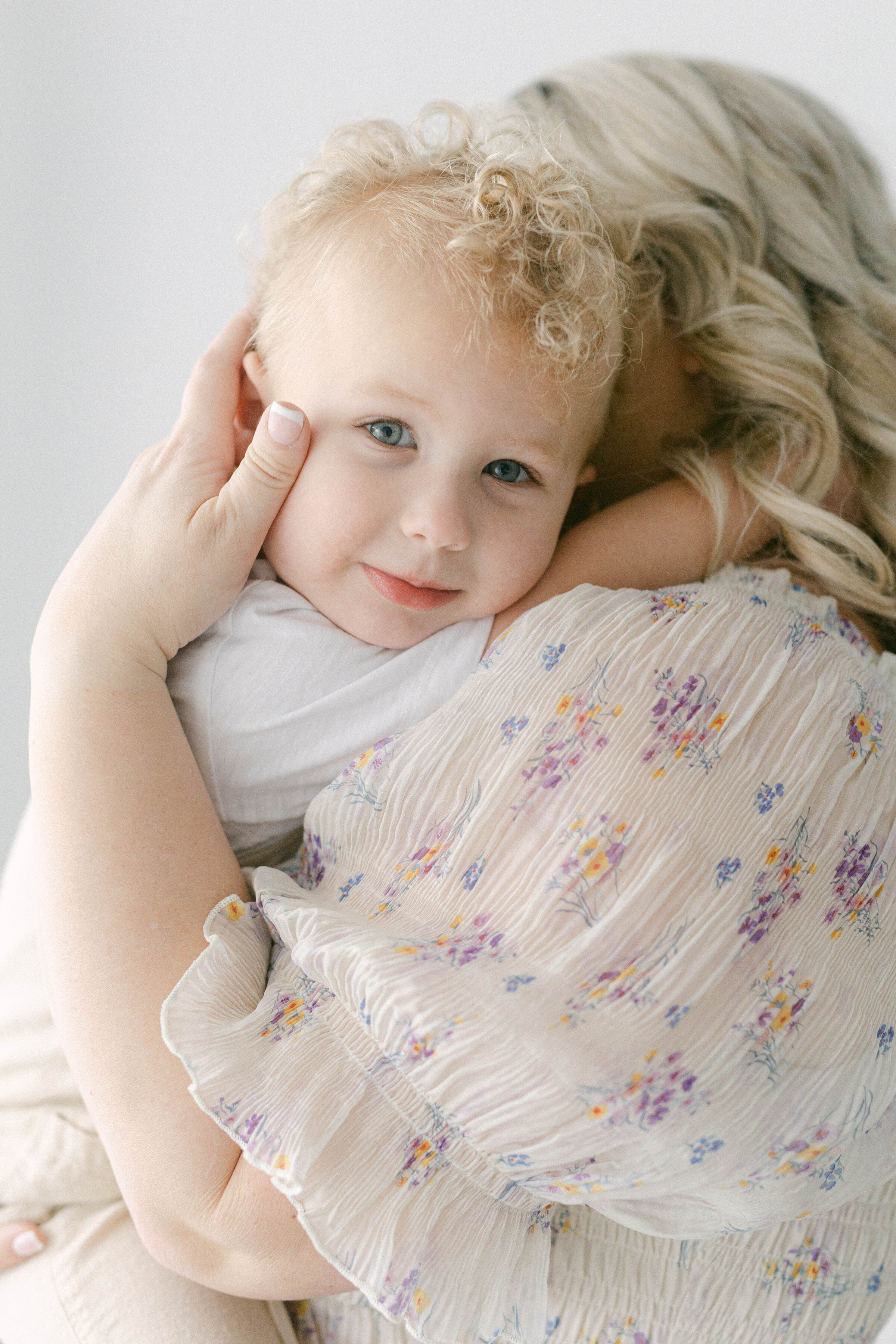 little boy smiling at camera being held by women  knoxville tennessee newborn photographer