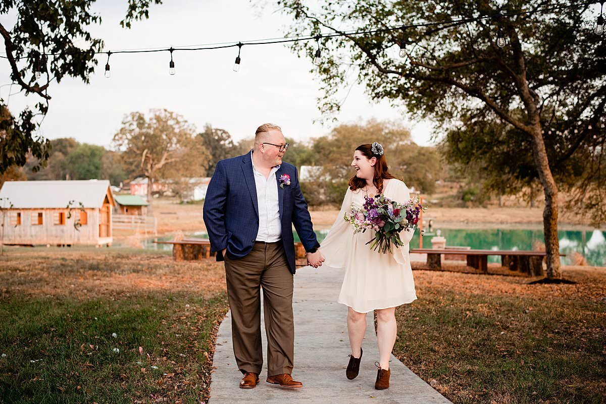 Couple strolling hand in hand after elopement  at Magnolia Barn