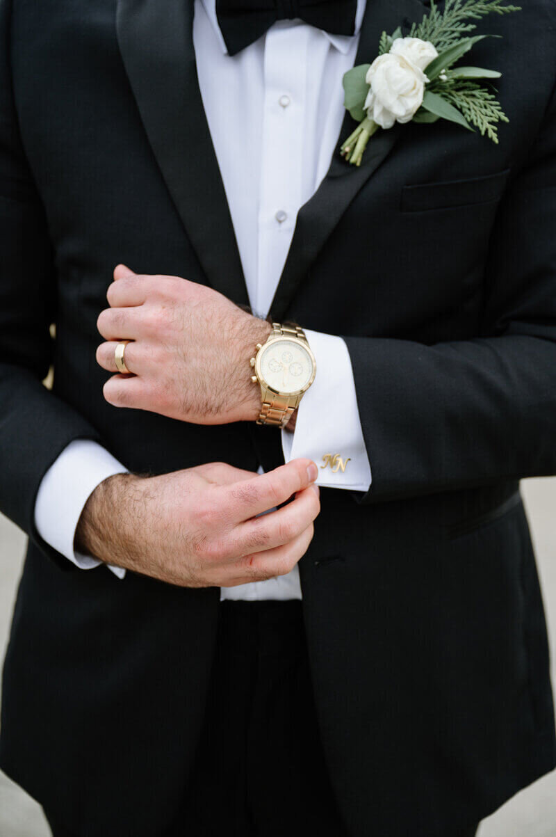 groom adjusting cufflinks taken by lexington wedding photographer